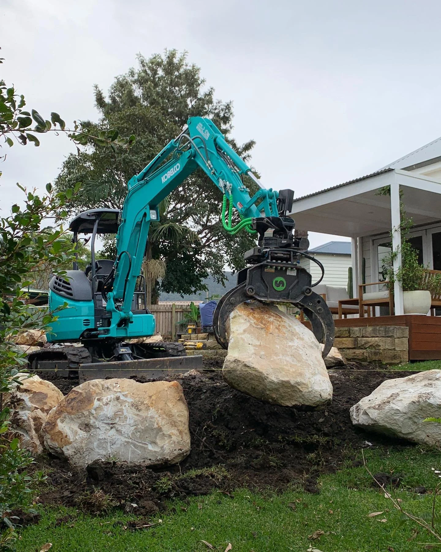 Another sandstone boulder wall going in.  Clients are always surprised when it&rsquo;s just me showing up to the job site with my arsenal of machines, but you know what, they show up everyday, don&rsquo;t complain, and get the job done.  Investing in