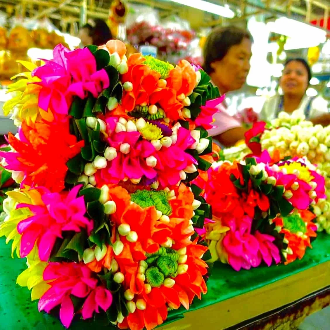 Female private guide shows flower market in Bangkok on tour