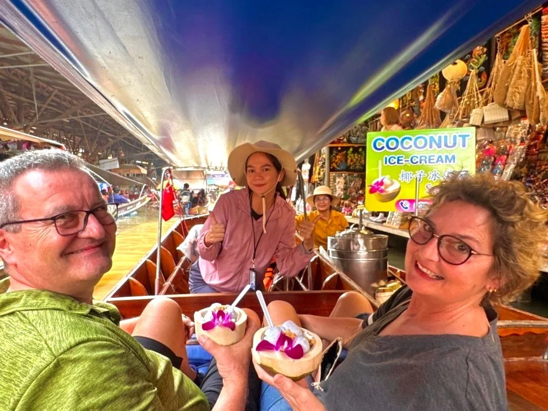 Local vendor selling tropical foods from a boat at Damnoen Saduak Floating Market in Thailand, part of a private guided tour package