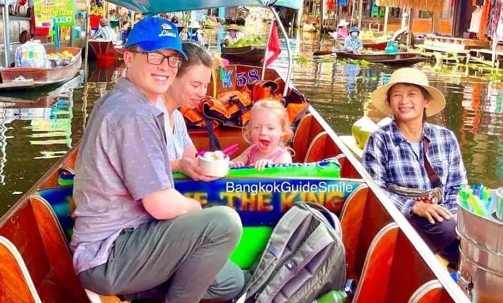 Family with kid enjoy time on boat at Floating Market Damnoen Saduak with private guide from Bangkok