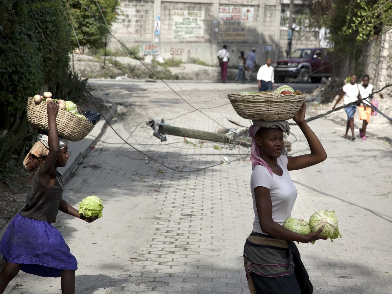 Women cross the street in Haiti after the earthquake