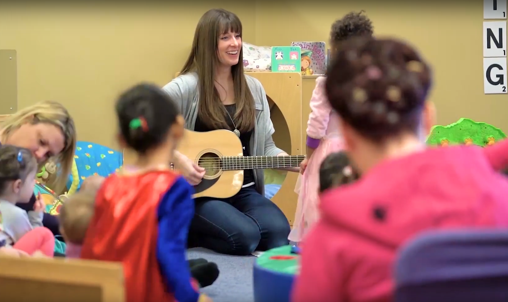 paula playing guitar to captive audience.png