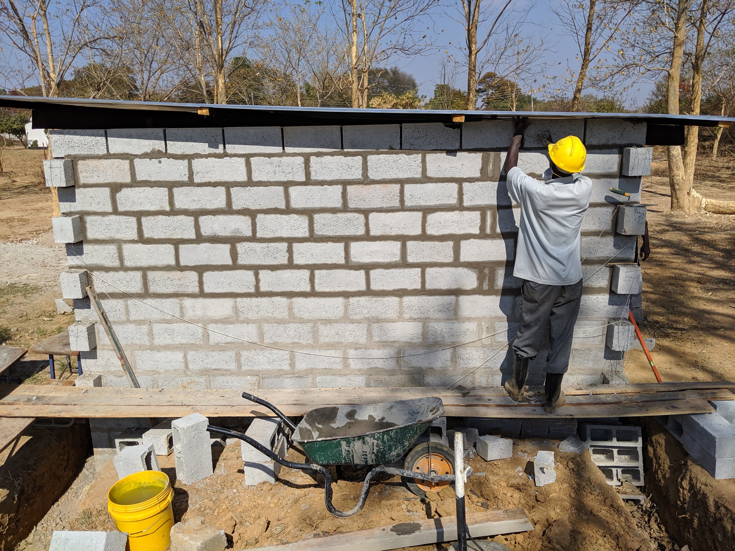 James, an impressively efficient, focused, and meticulous worker, putting the final touches on the wall.