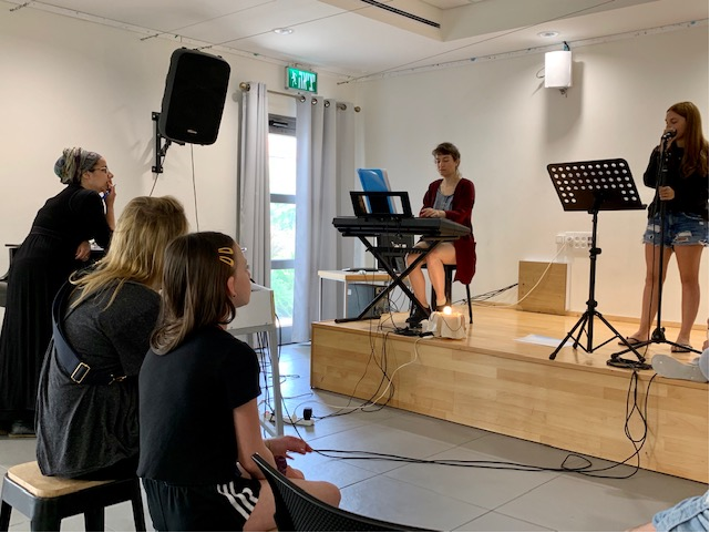 A girl performs songs learned in Music Therapy