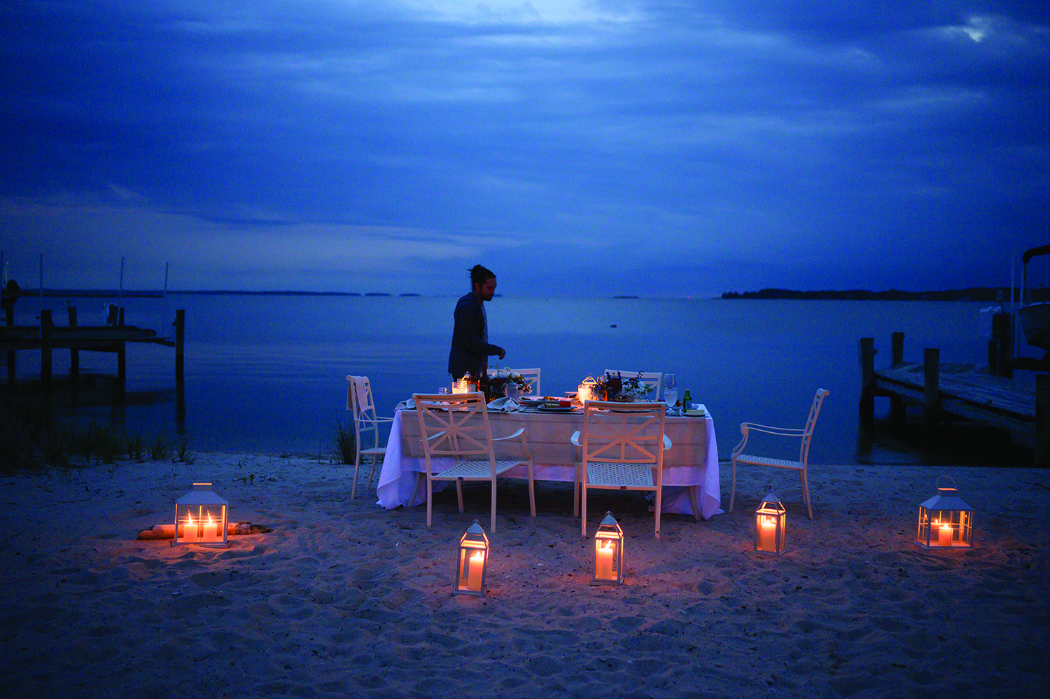NIGHT SHIFT We lit lanterns and talked and drank into the night, the heavy linens serving as blankets over our legs as the Bay winds blew in. A few lights shone across the water and we toasted to our neighbors, hoping their suppers were just as long-lasting. Beach house rented through tidewatervacations.com . Visit TourTalbot.org to begin planning your trip.