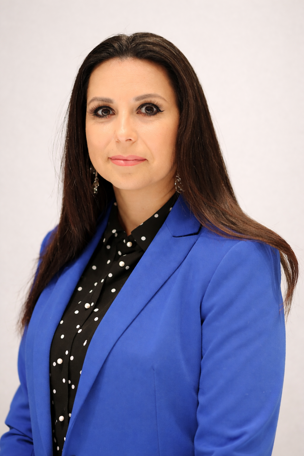 Confident professional headshot in blue blazer.png