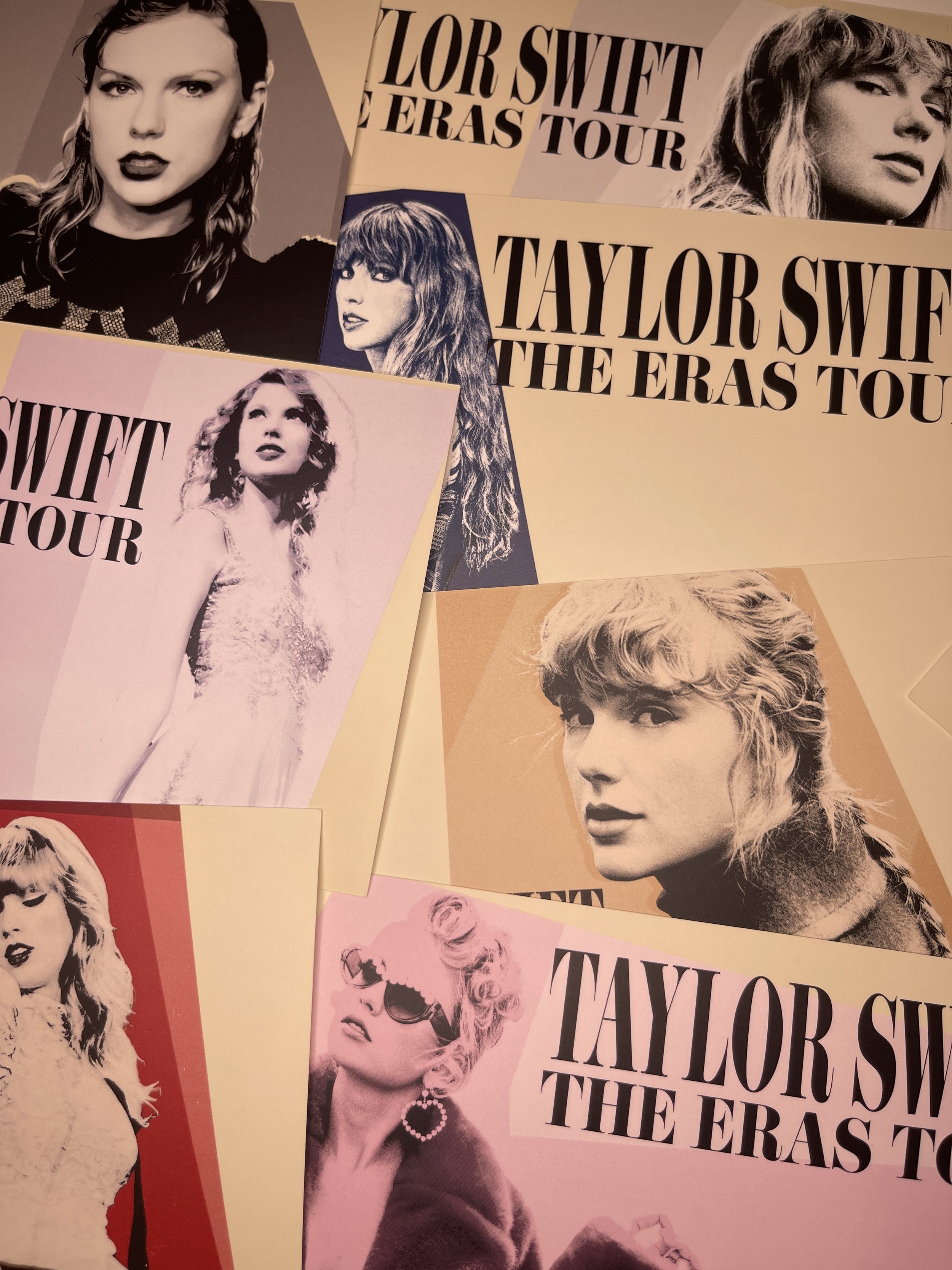 A pile of postcards from Taylor Swift's Eras Tour VIP box.