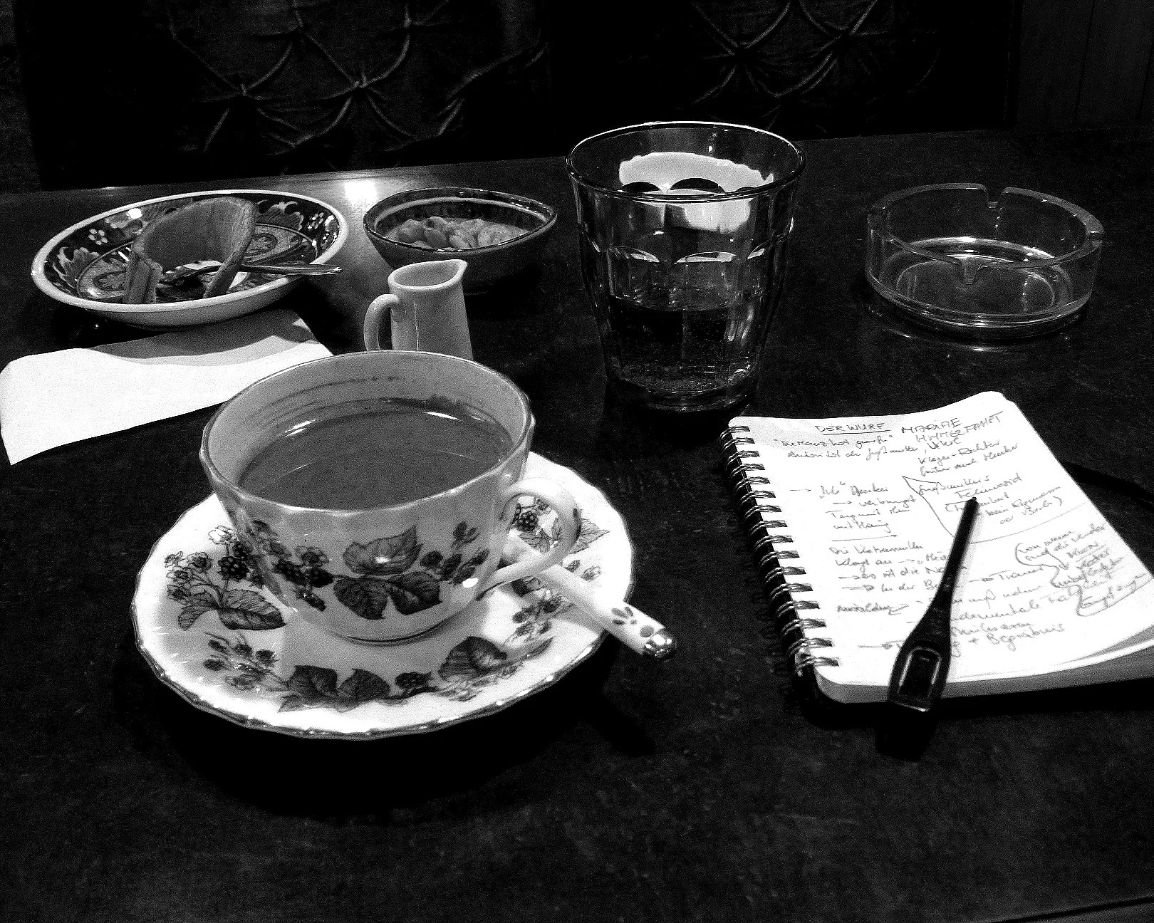 A Japanese Café, a paradise for smokers who I am not, me scribbling notes about the short story “Werfen” (published in “ Island Universe ”) and hailing the queen of the café- a cat