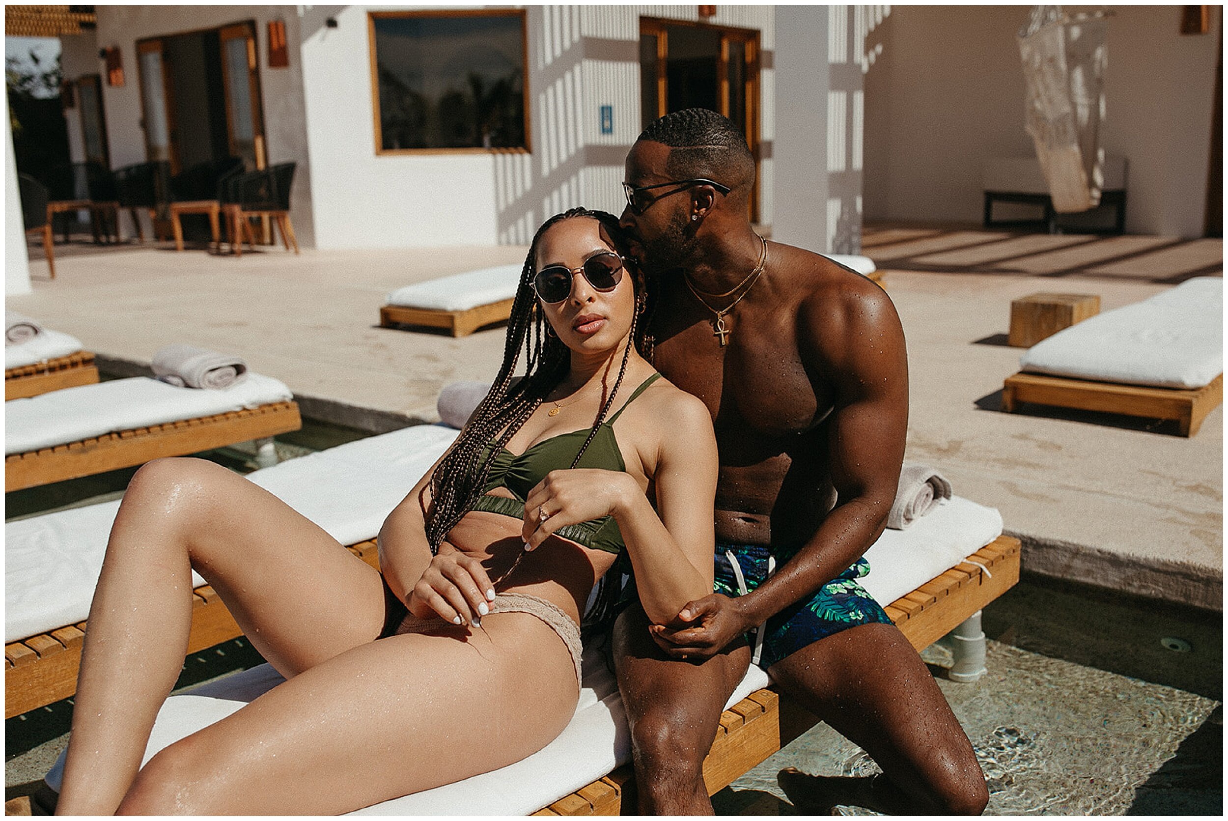 couple lounging by pool on chair