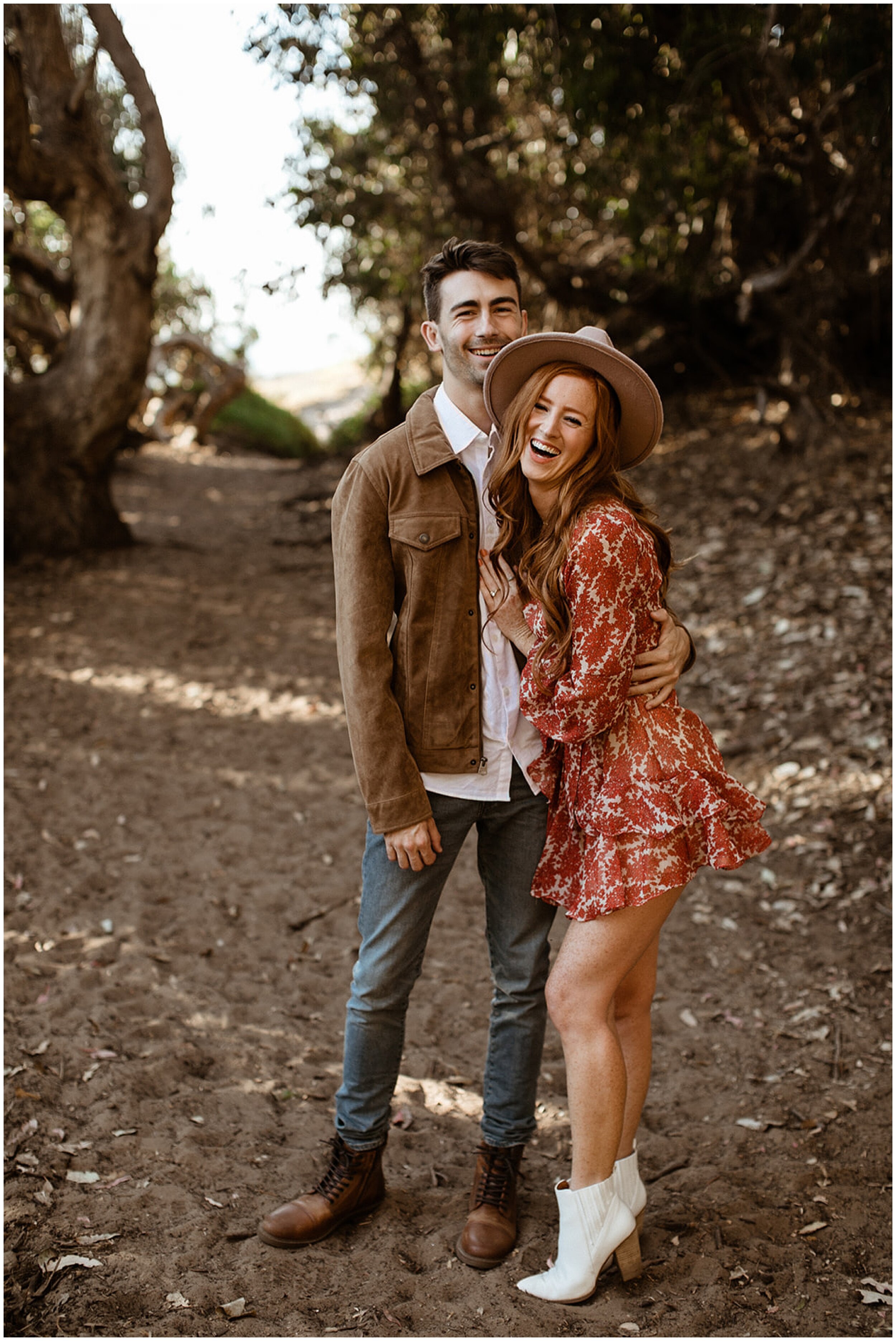 couple smiling and laughing in forest