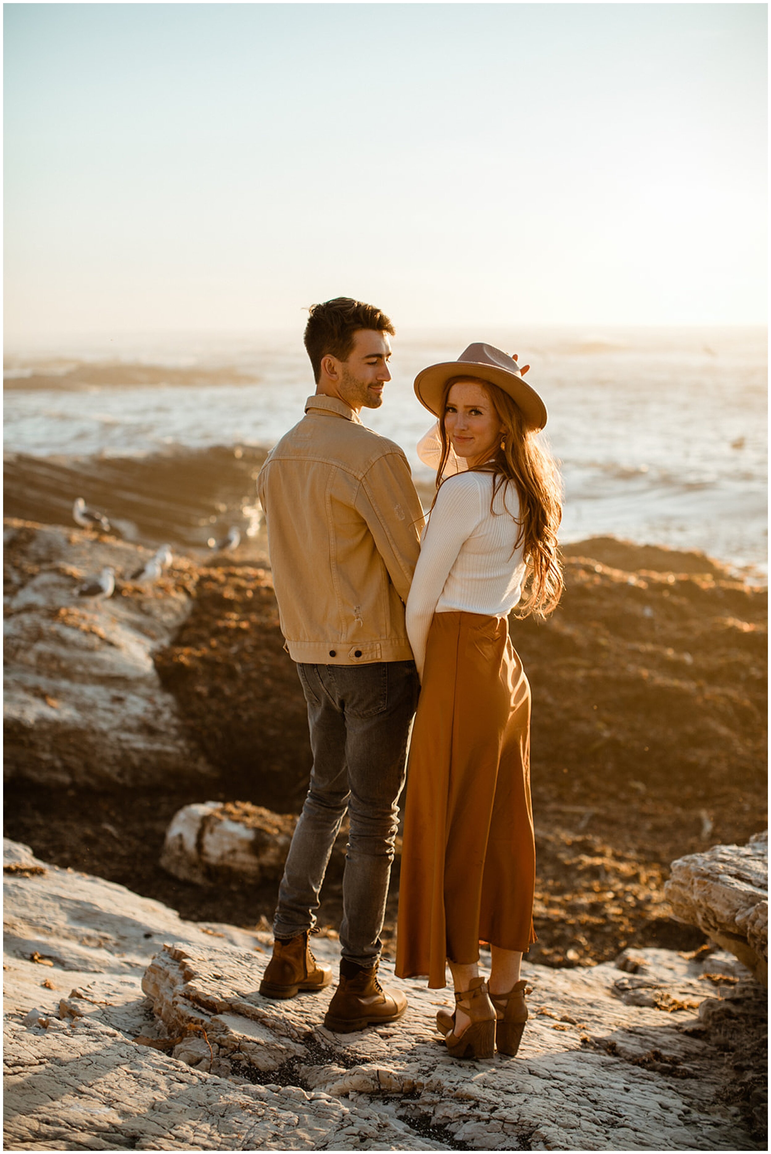 couple posing on beach at sunset