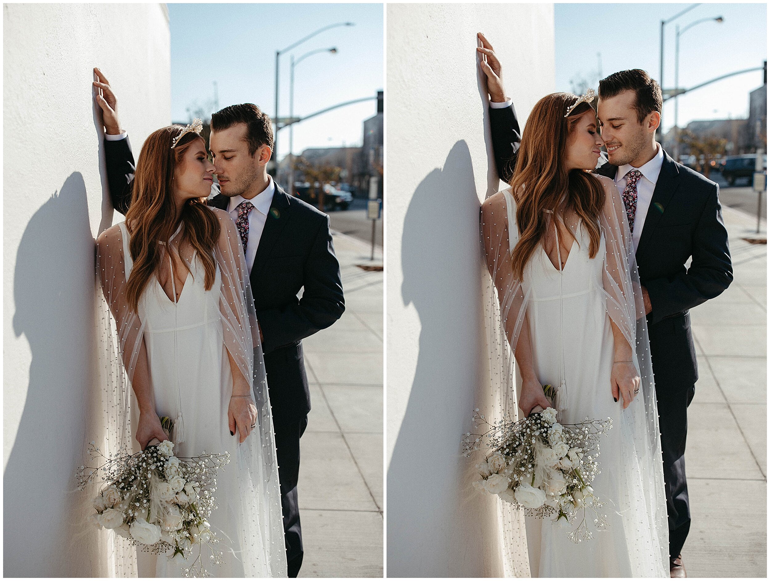 bride and groom leaning against white wall