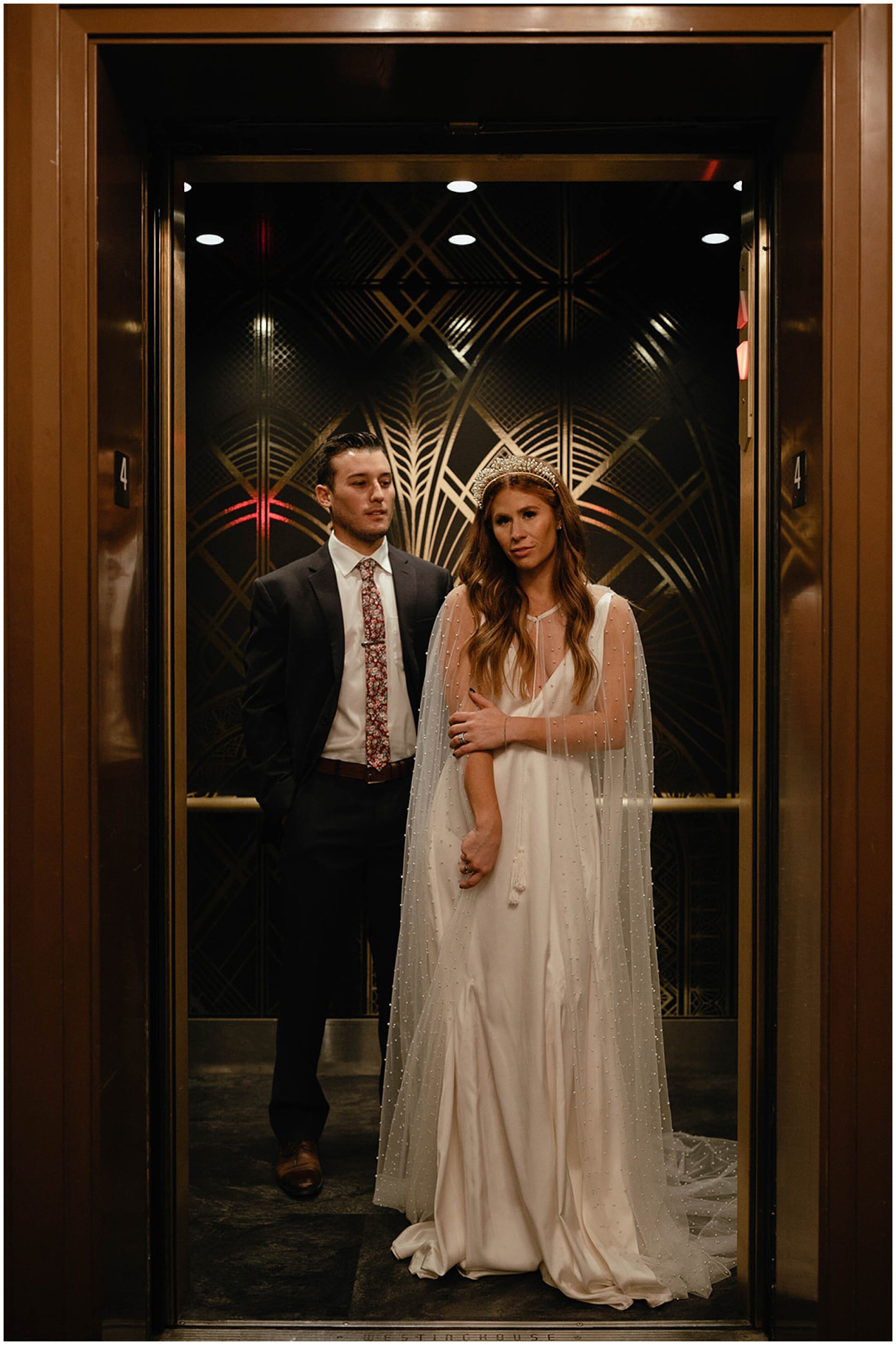 bride and groom posing in elevator
