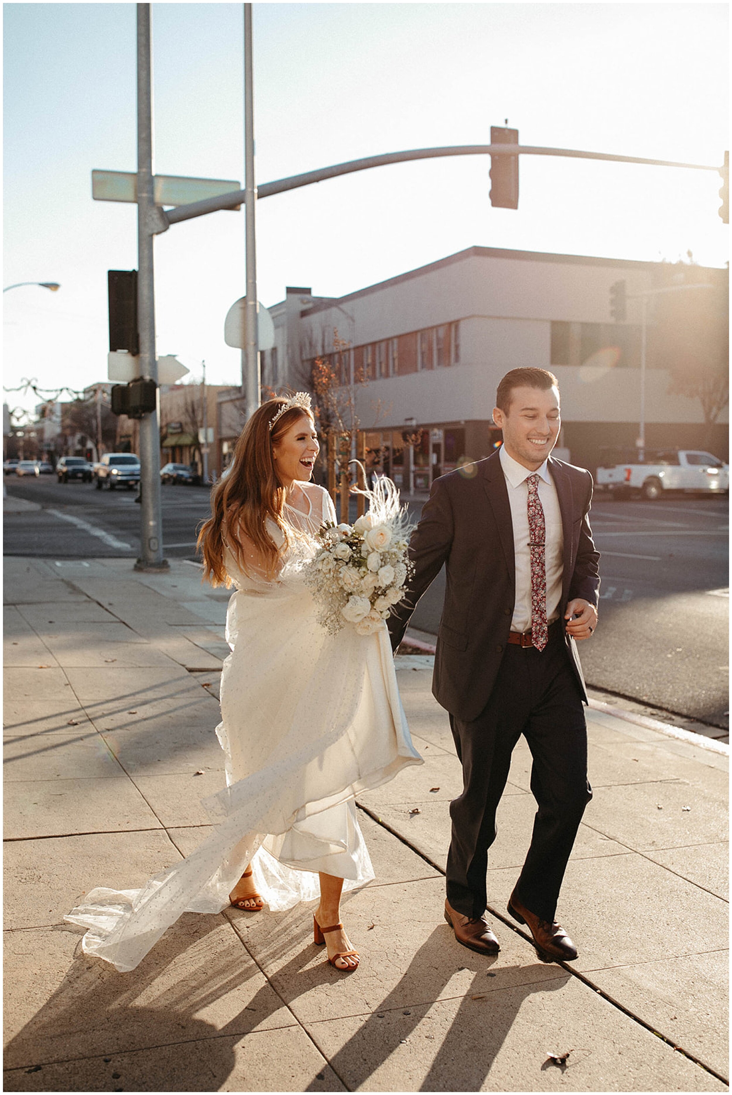 bride and groom running down street