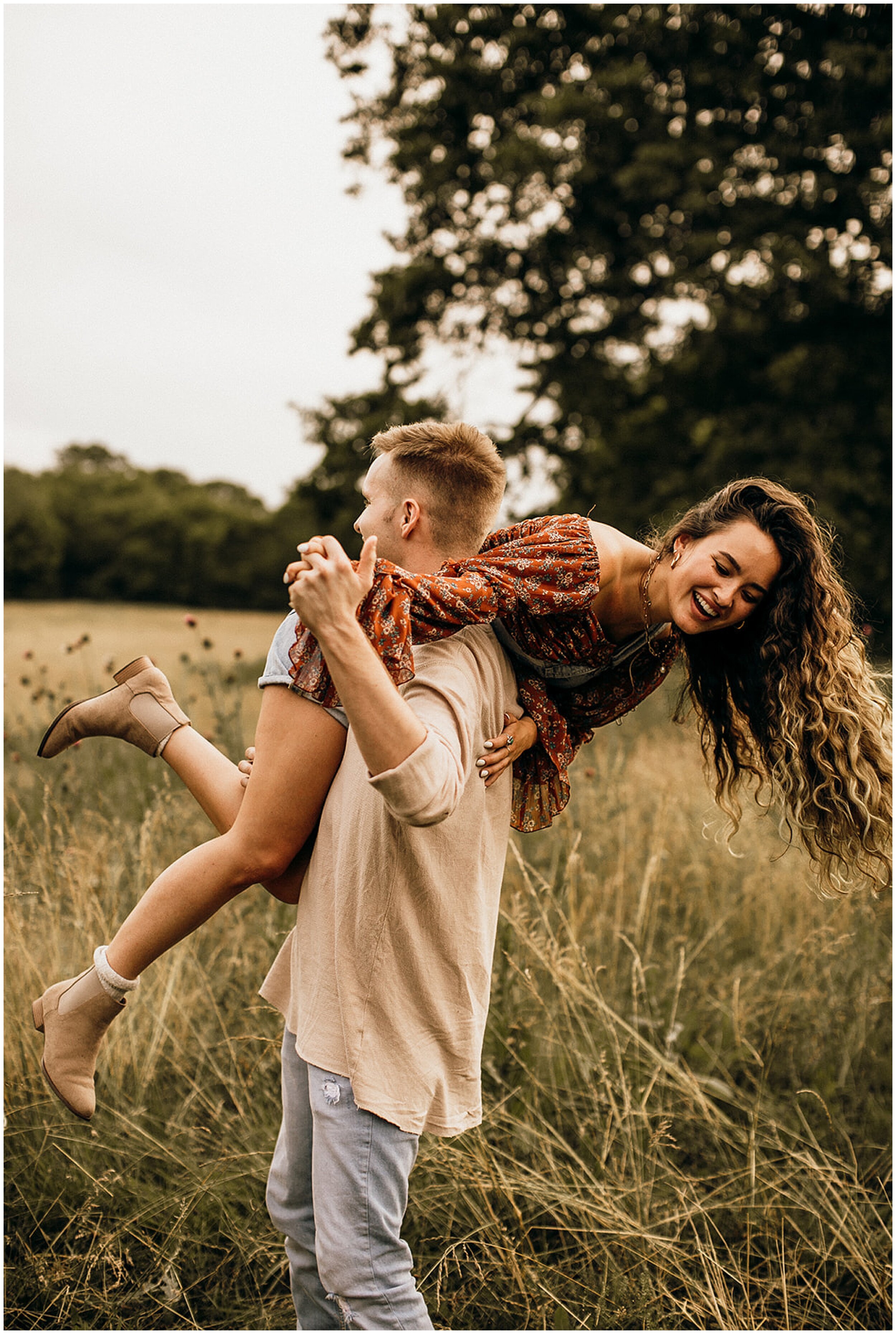 couple dancing around in field