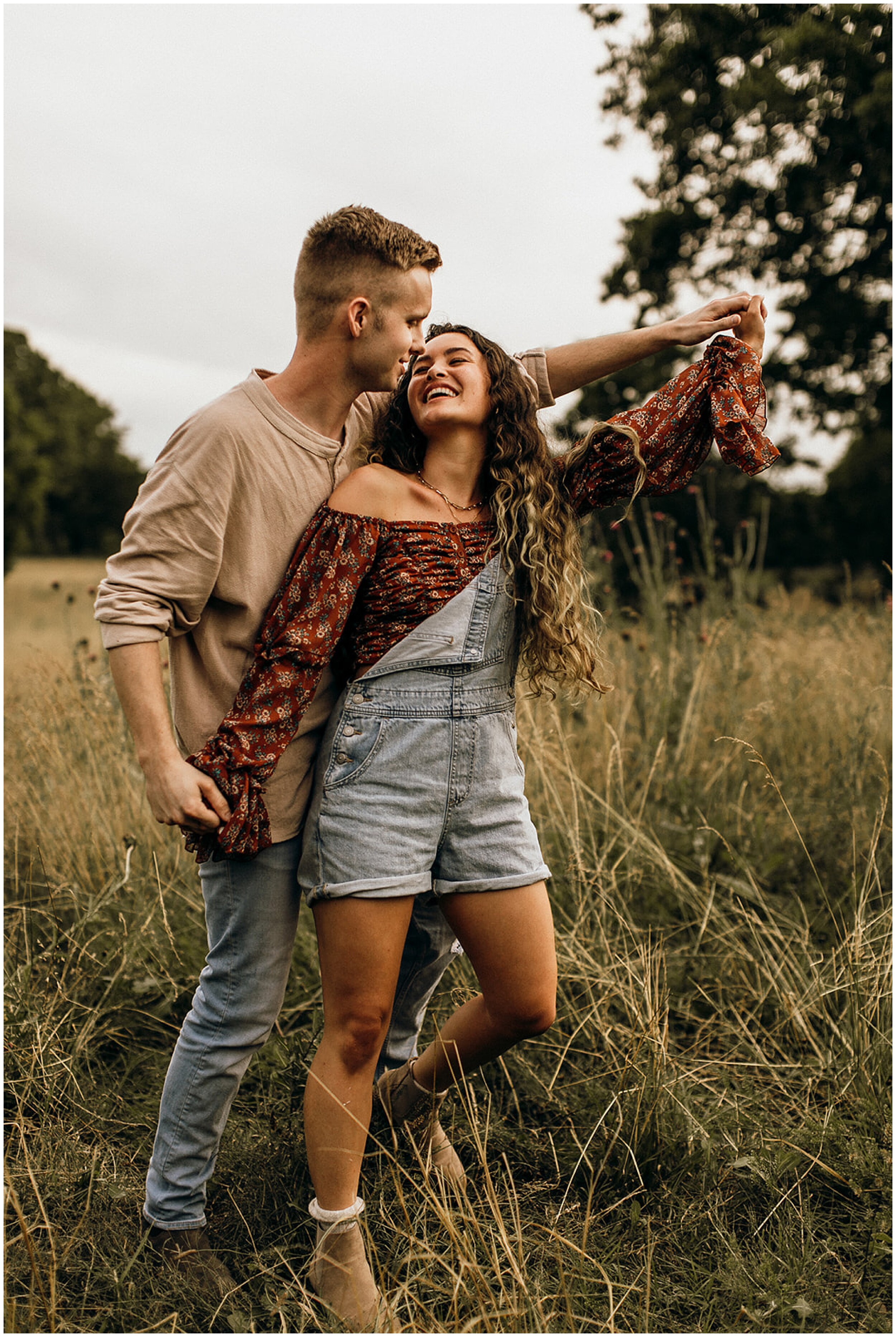 couple dancing and kissing in field