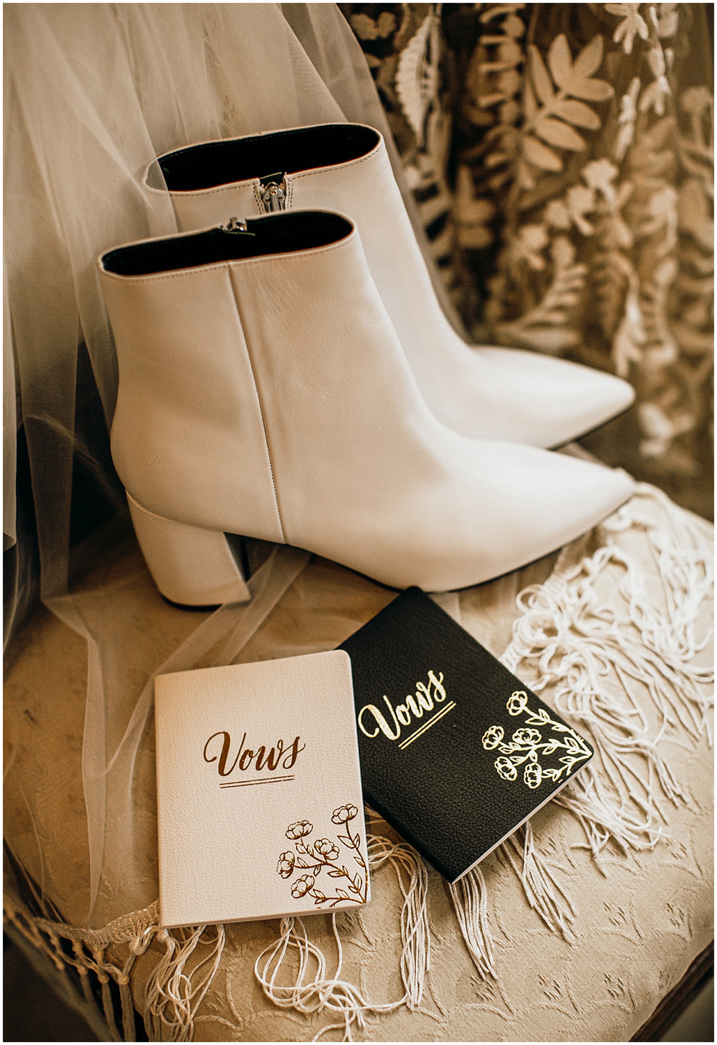 white bridal boots with vow books on chair
