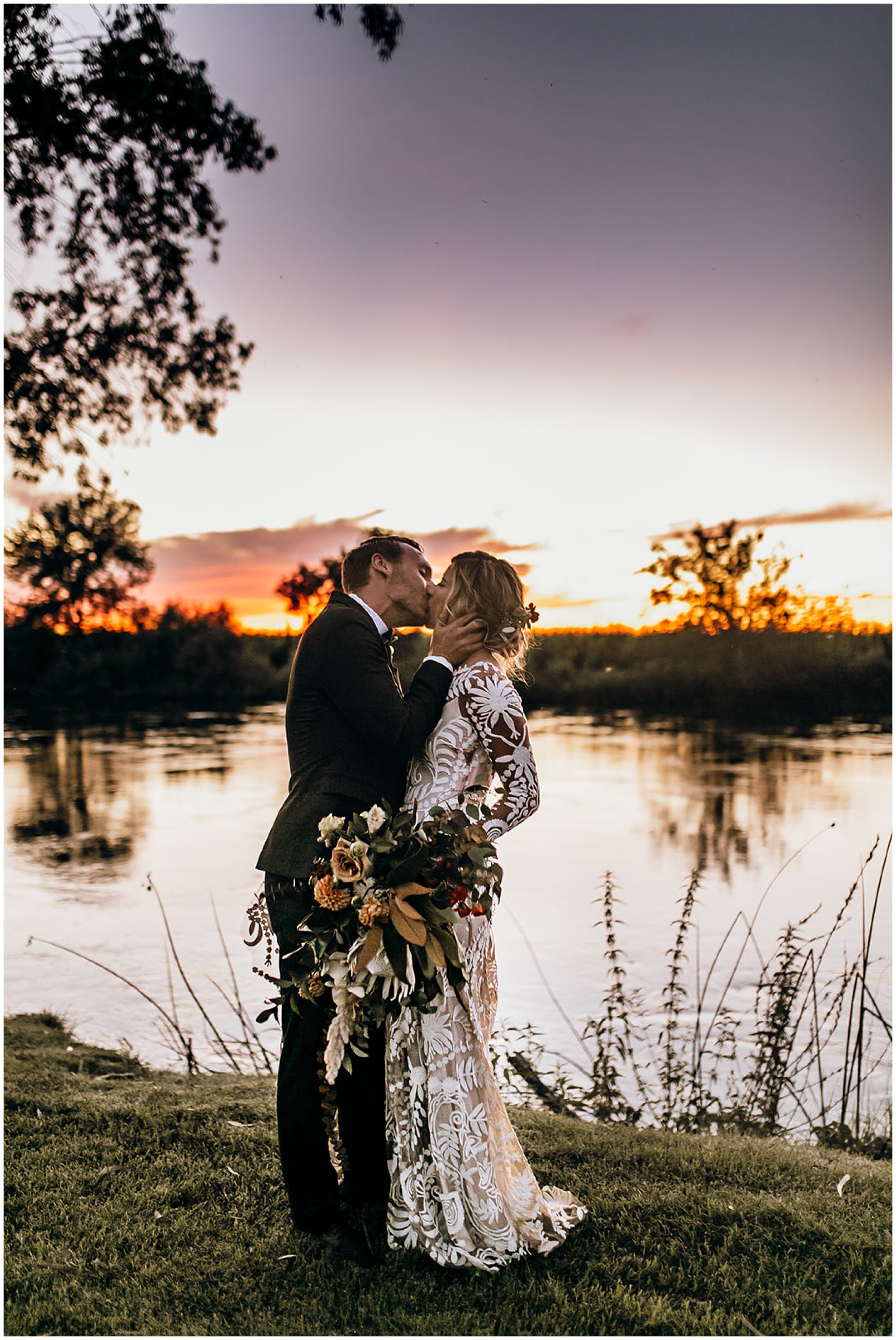 bride and groom kissing at sunset