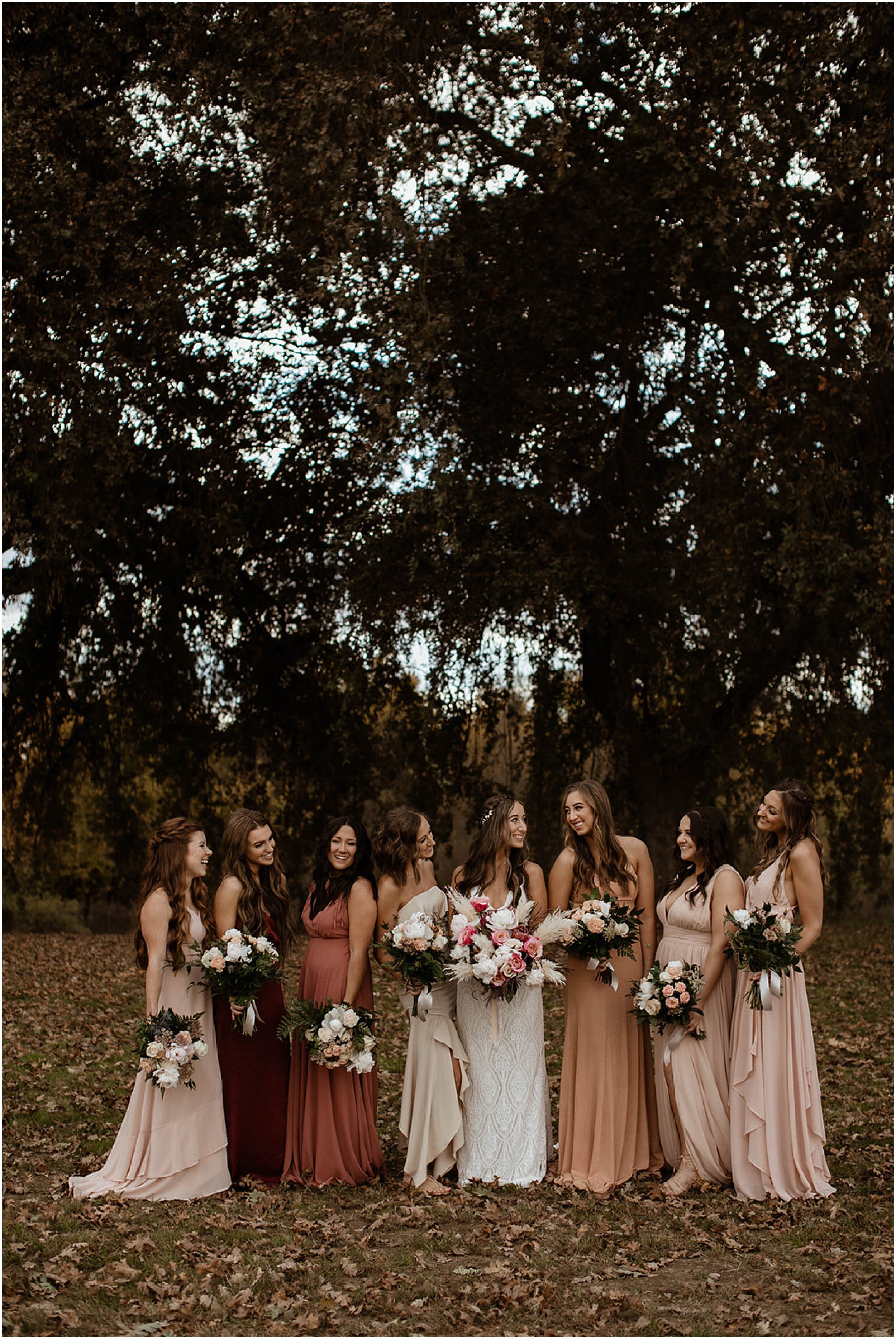bridal party standing in forest