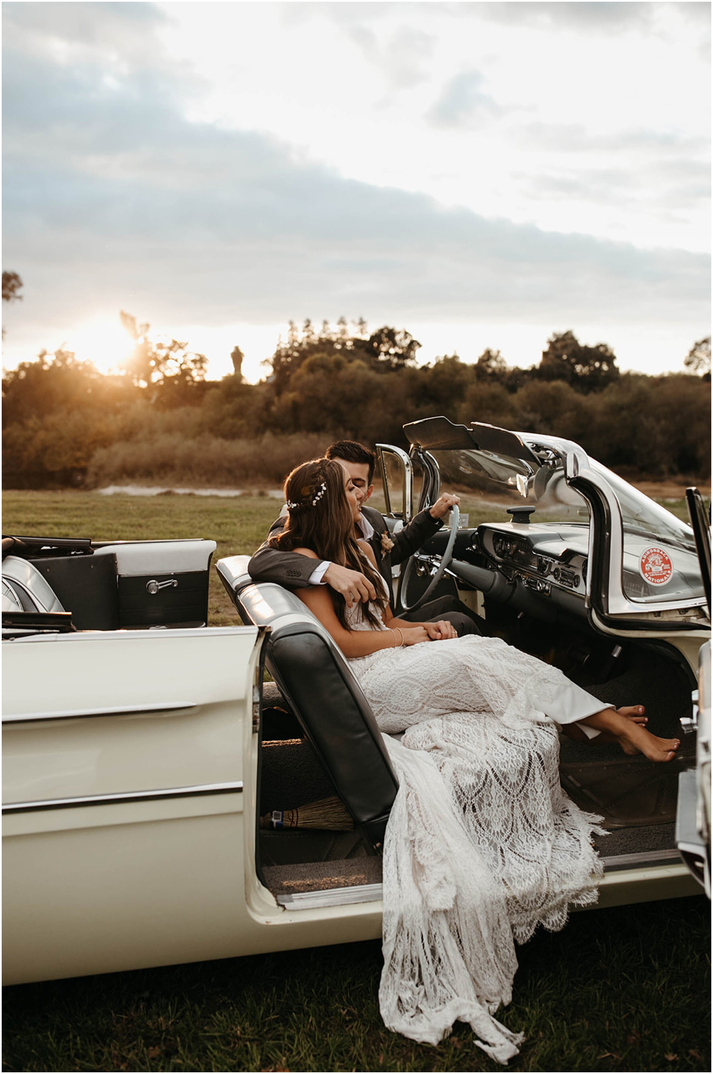 bride and groom sitting in vintage car