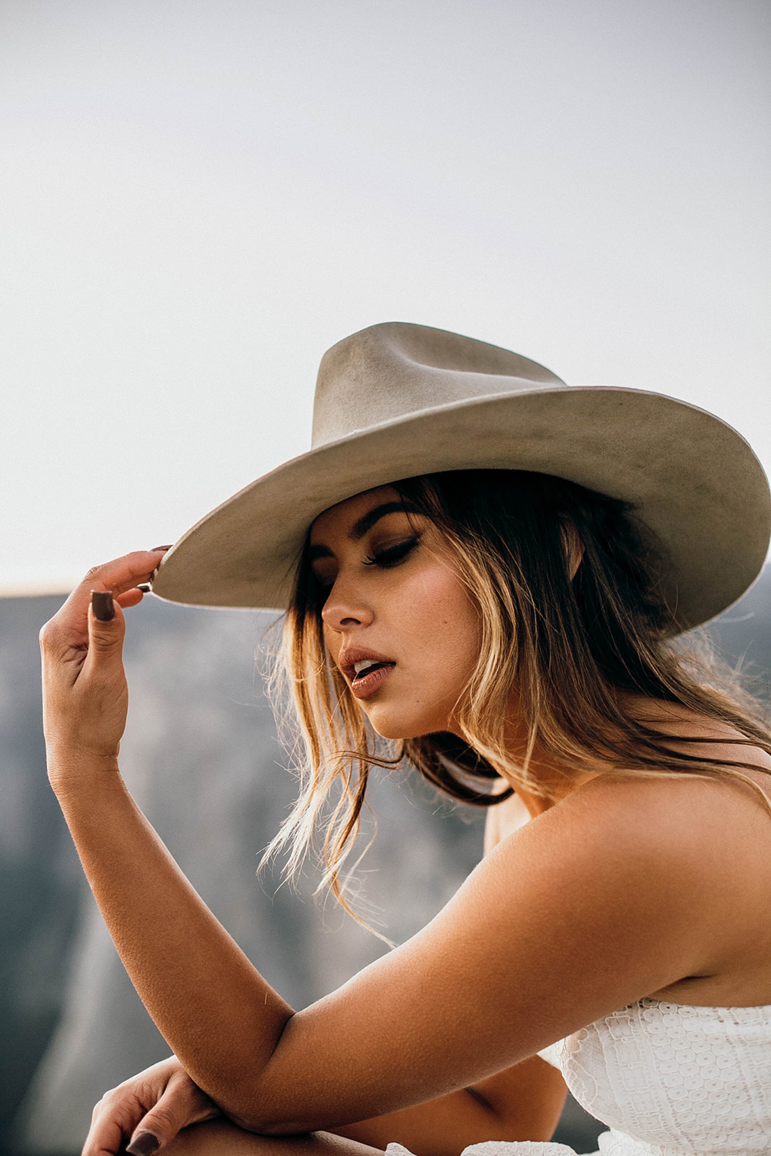 bride wearing boho hat