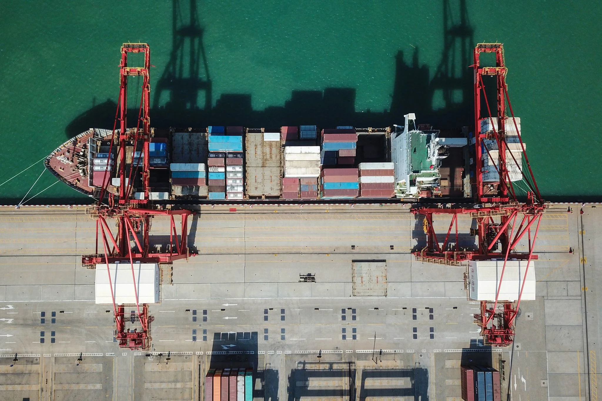 A cargo ship berthing at a port in Lianyungang, China. Oceangoing goods from China won’t be hit by the new tariffs until they reach American ports over the next few weeks. Credit Agence France-Presse — Getty Images