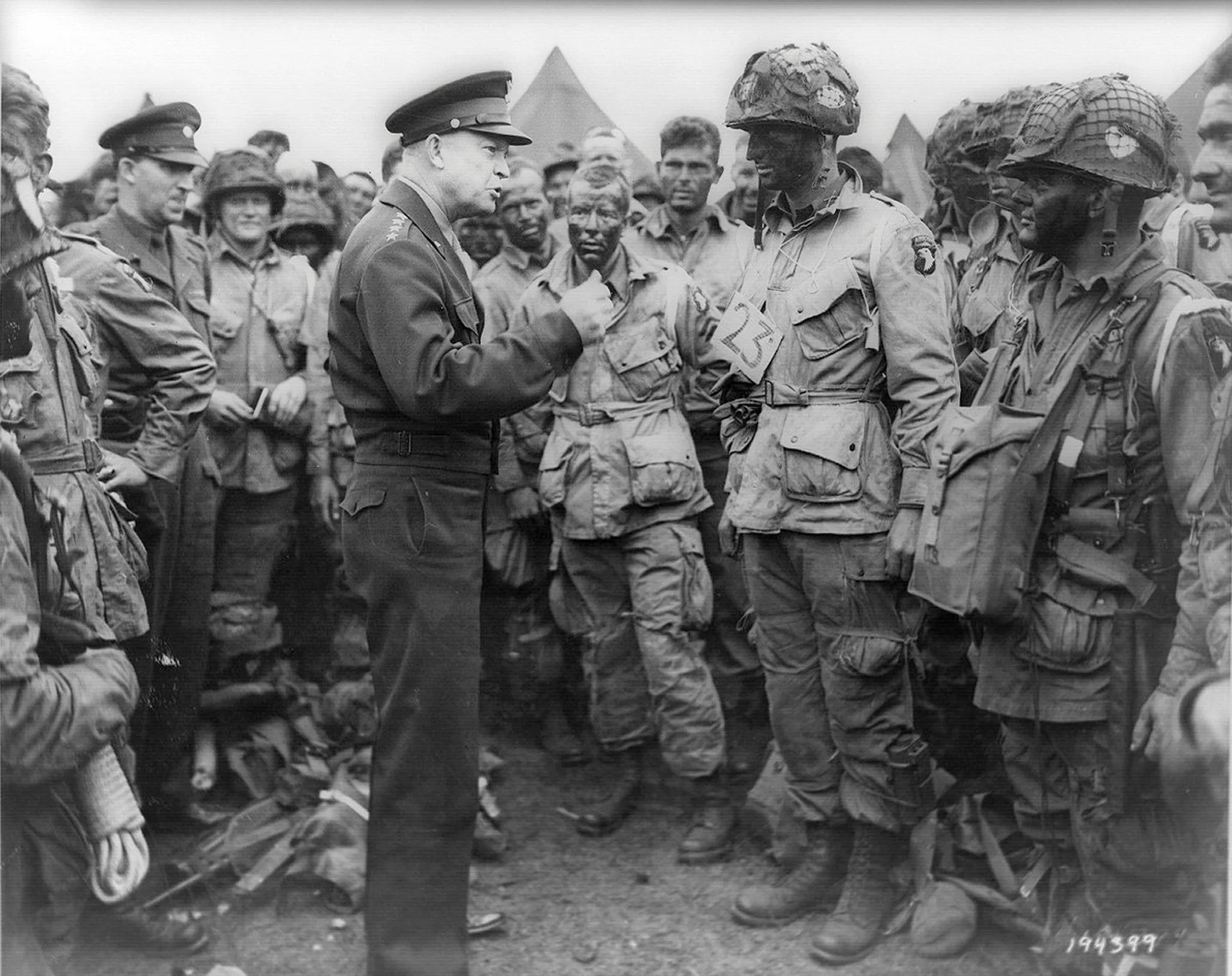 The Supreme Commander of Allied Forces, Gen. Dwight D. Eisenhower, speaking with American Army paratroopers of Easy Company, 502nd Parachute Infantry Regiment of the 101st Airborne Division, at Greenham Common Airfield in Britain on June 5, 1944. Credit U.S. National Archives