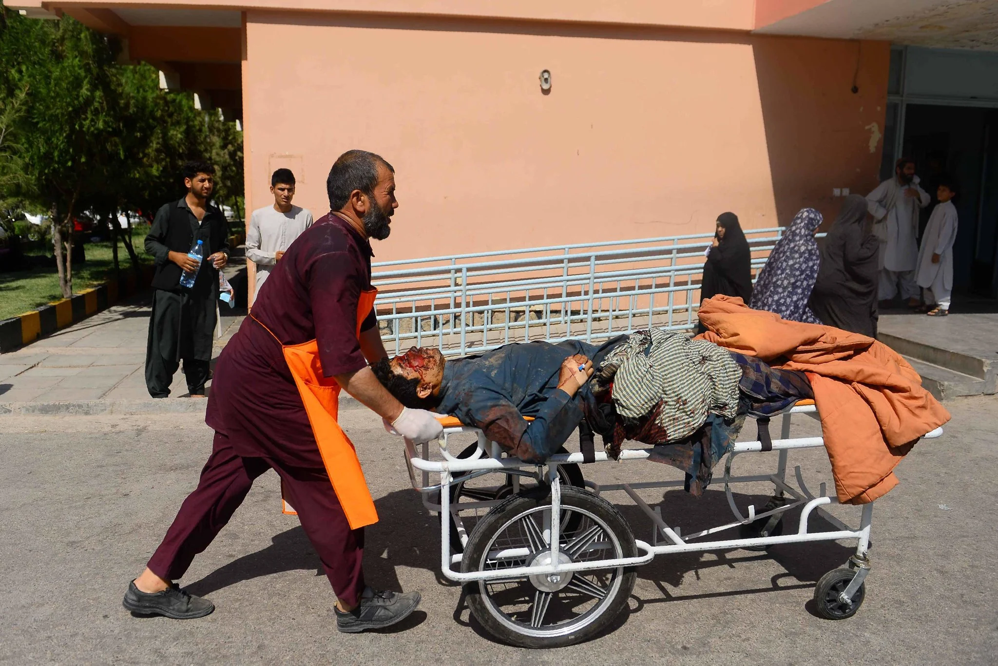 An injured man being transported on a stretcher on Wednesday after a bus hit a roadside bomb on the highway between the Afghan cities of Kandahar and Herat. Credit Hoshang Hashimi/Agence France-Presse — Getty Images