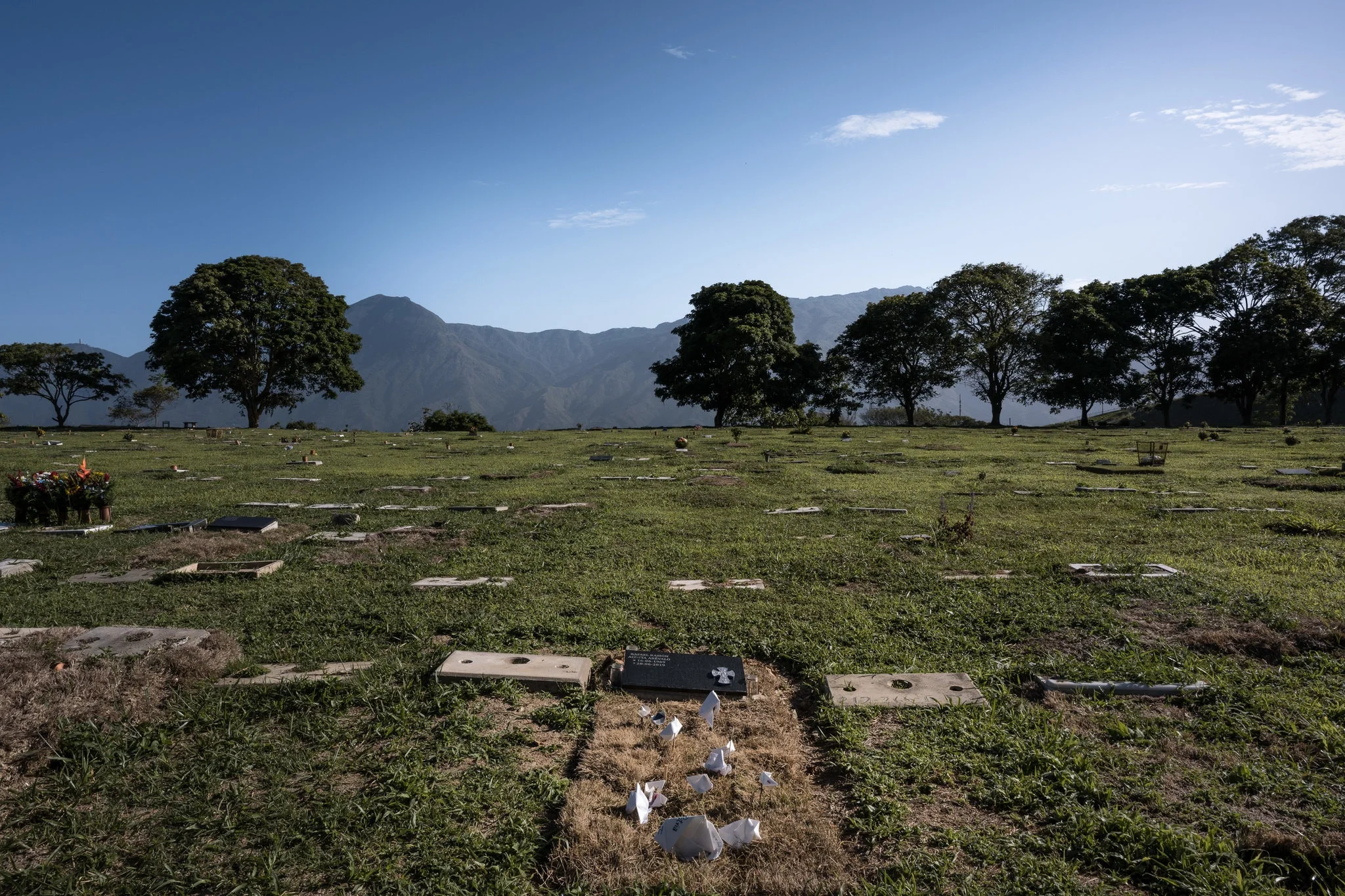 The grave of Rafael Acosta, a retired navy captain who died in government custody. He was electrocuted, among other things. Credit Adriana Loureiro Fernandez for The New York Times