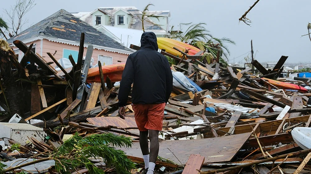A man walks through the rubble in the aftermath of Hurricane Dorian on the Great Abaco island town of Marsh Harbour, Bahamas (Dante Carrer/Reuters)