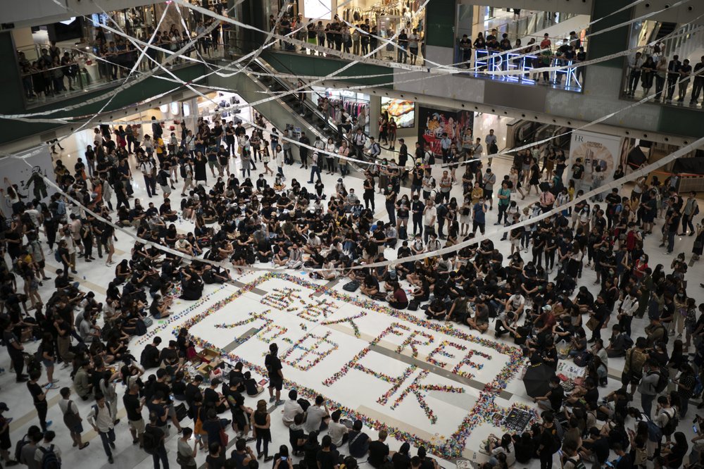 Residents gather at a shopping mall in Sha Tin to protest a teenage demonstrator shot at close range in the chest by a police officer and condemn police tactics and demand accountability, in Hong Kong, Wednesday, Oct. 2, 2019. The shooting Tuesday during widespread anti-government demonstrations on China's National Day was a fearsome escalation in Hong Kong's protest violence. The 18-year-old is the first known victim of police gunfire since the protests began in June. He was hospitalized and his condition was described by the government as stable on Wednesday. (AP Photo/Felipe Dana)