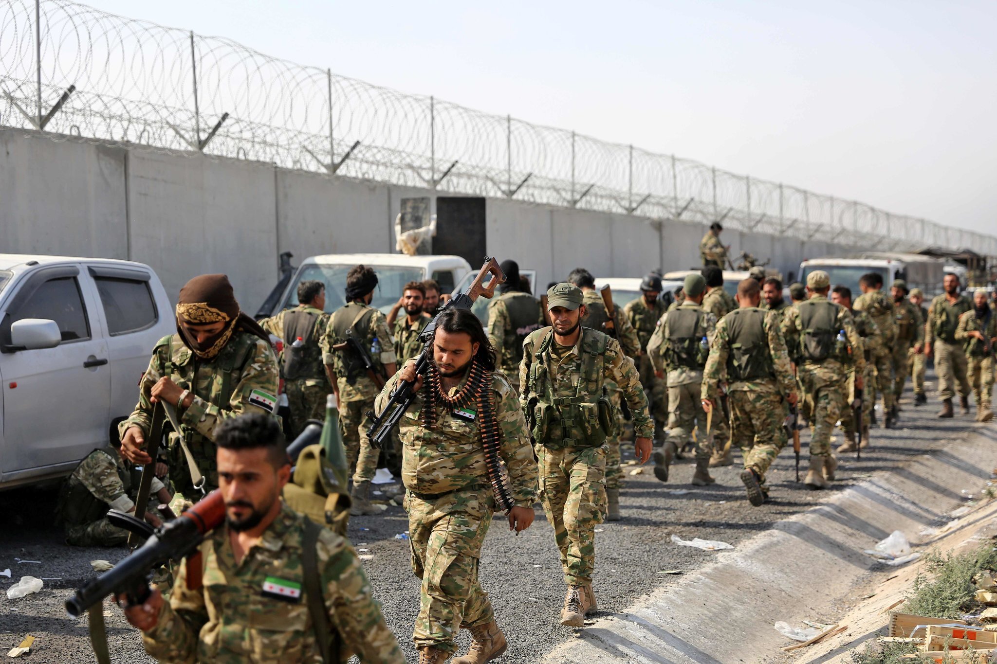 Pro-Turkish Syrian fighters along the Turkish side of the border on Friday. Credit Nazeer Al-Khatib/Agence France-Presse — Getty Images