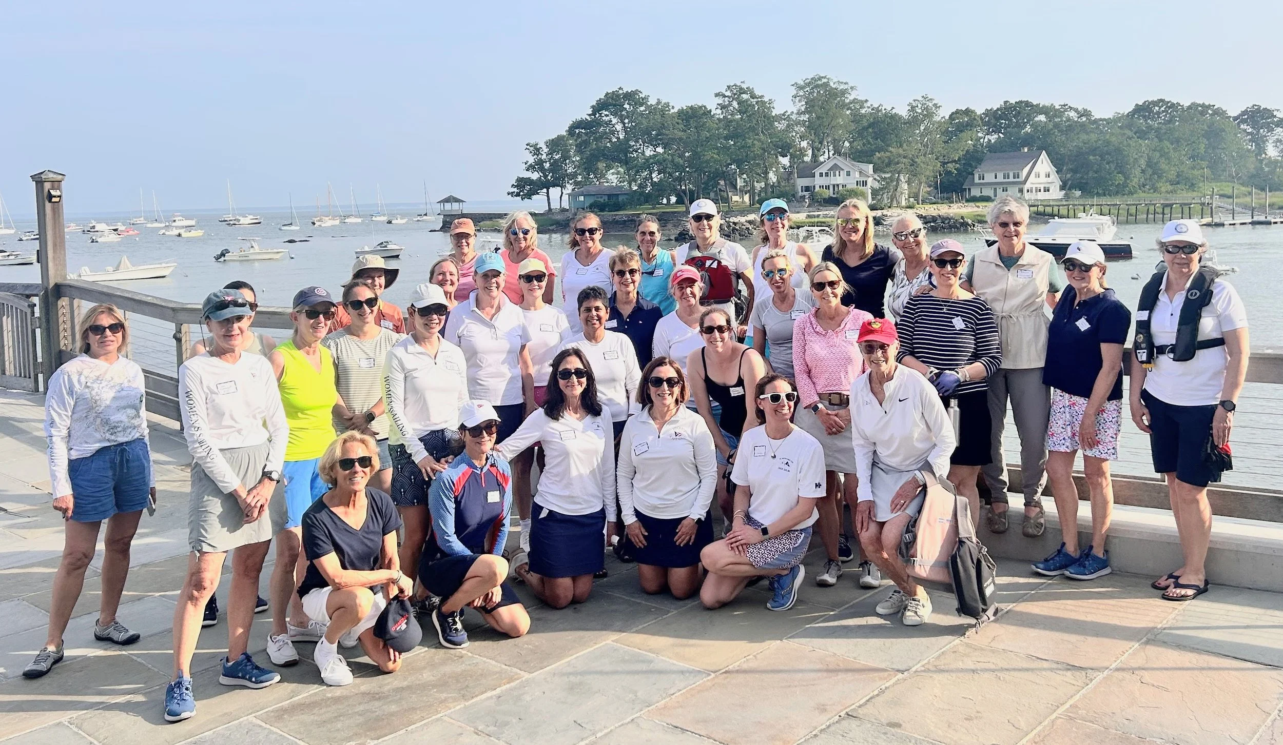 The women sailors of Noroton Yacht Club in Darien CT gather at water's edge during the 2025 WOW supper series