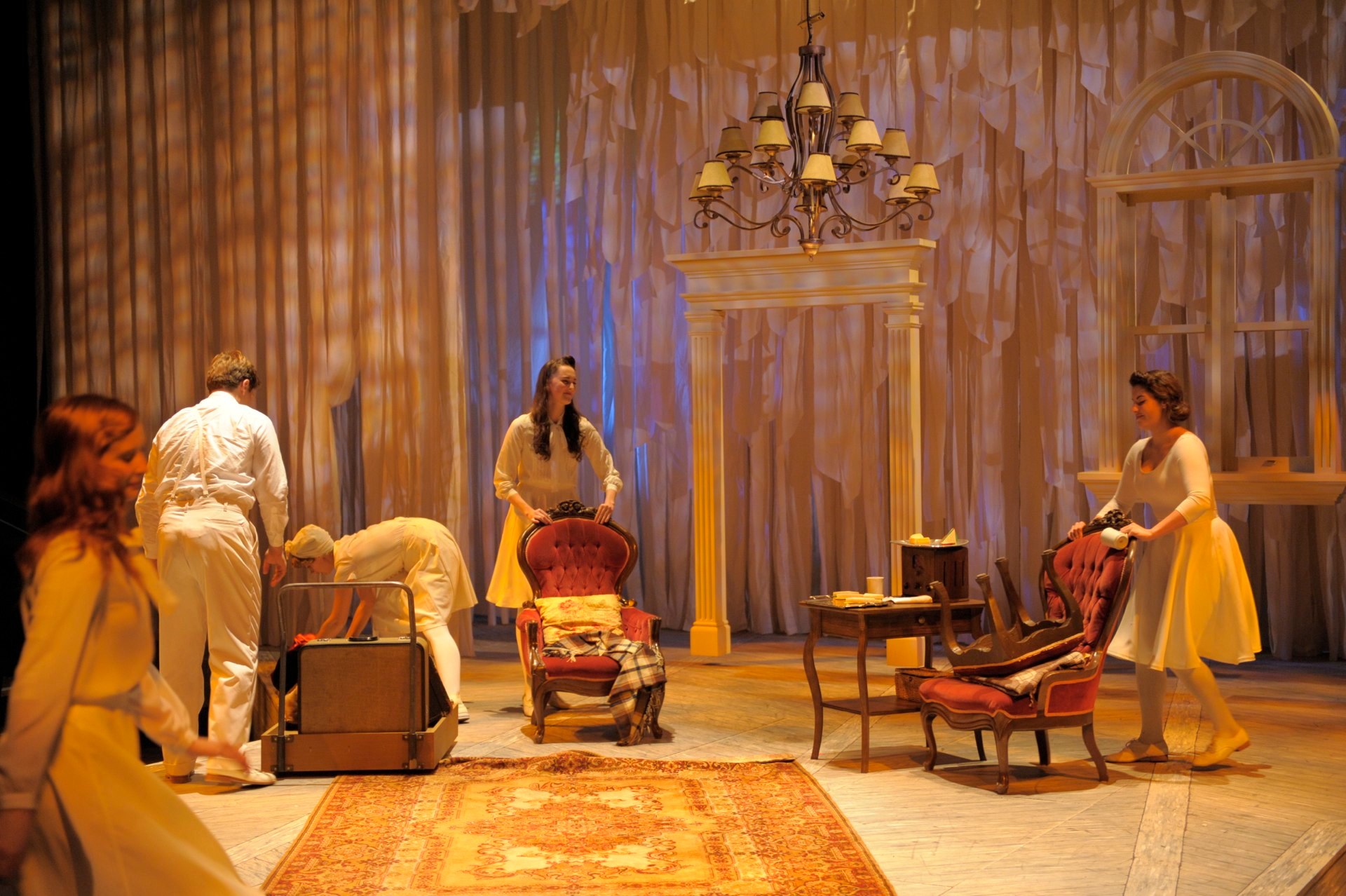 THE BASE costume for the actors was a personalized combination of off white layers that were added upon to create the different characters they became. This was best showcased during set changes when the performers came out to move furniture. No d
