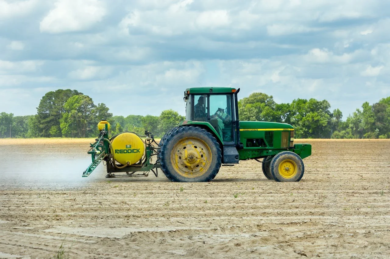 tractor spraying using a gum thickener for  spreadability