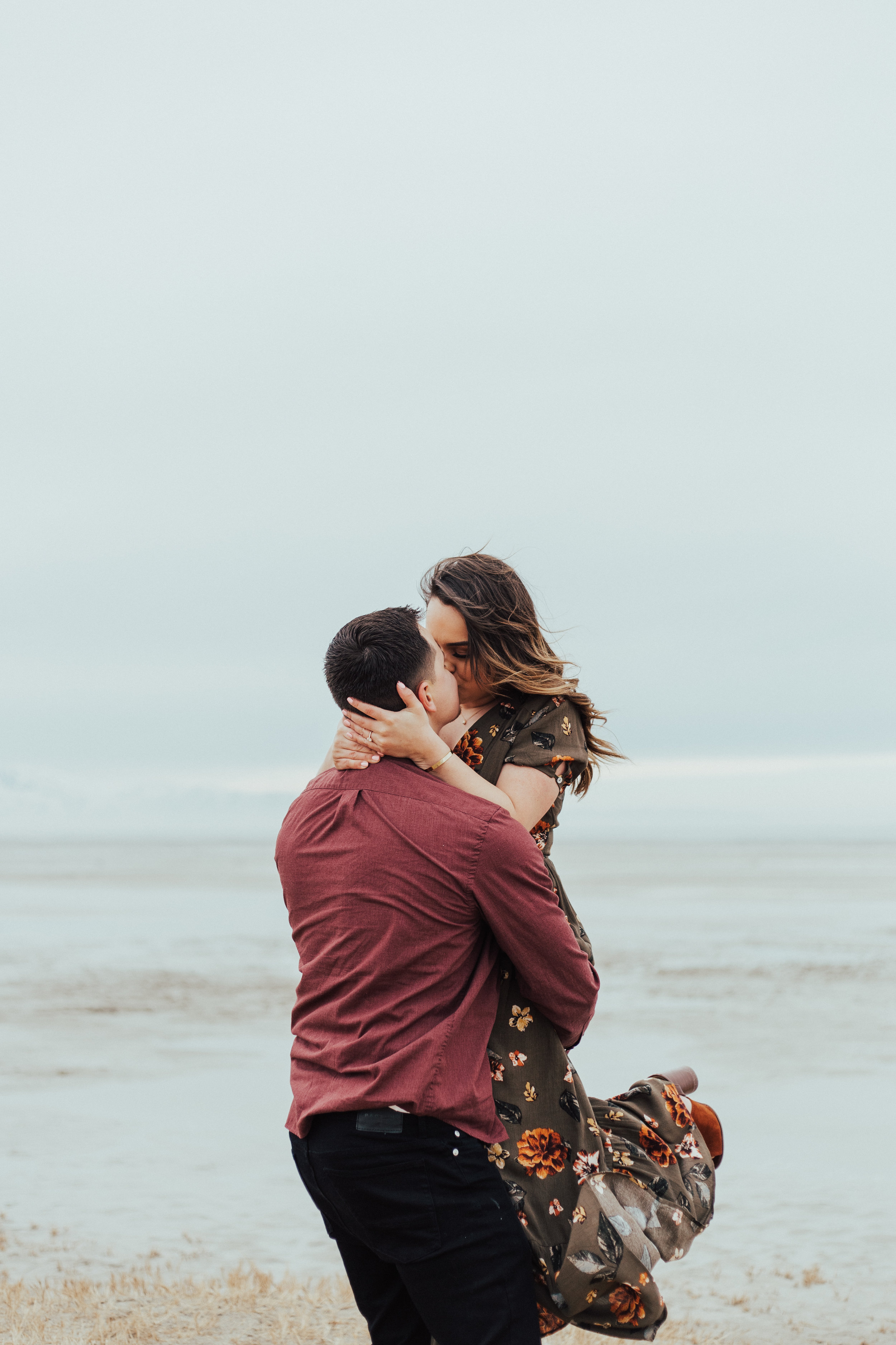 Romantic windy couple engagement photos twirling Utah photographer