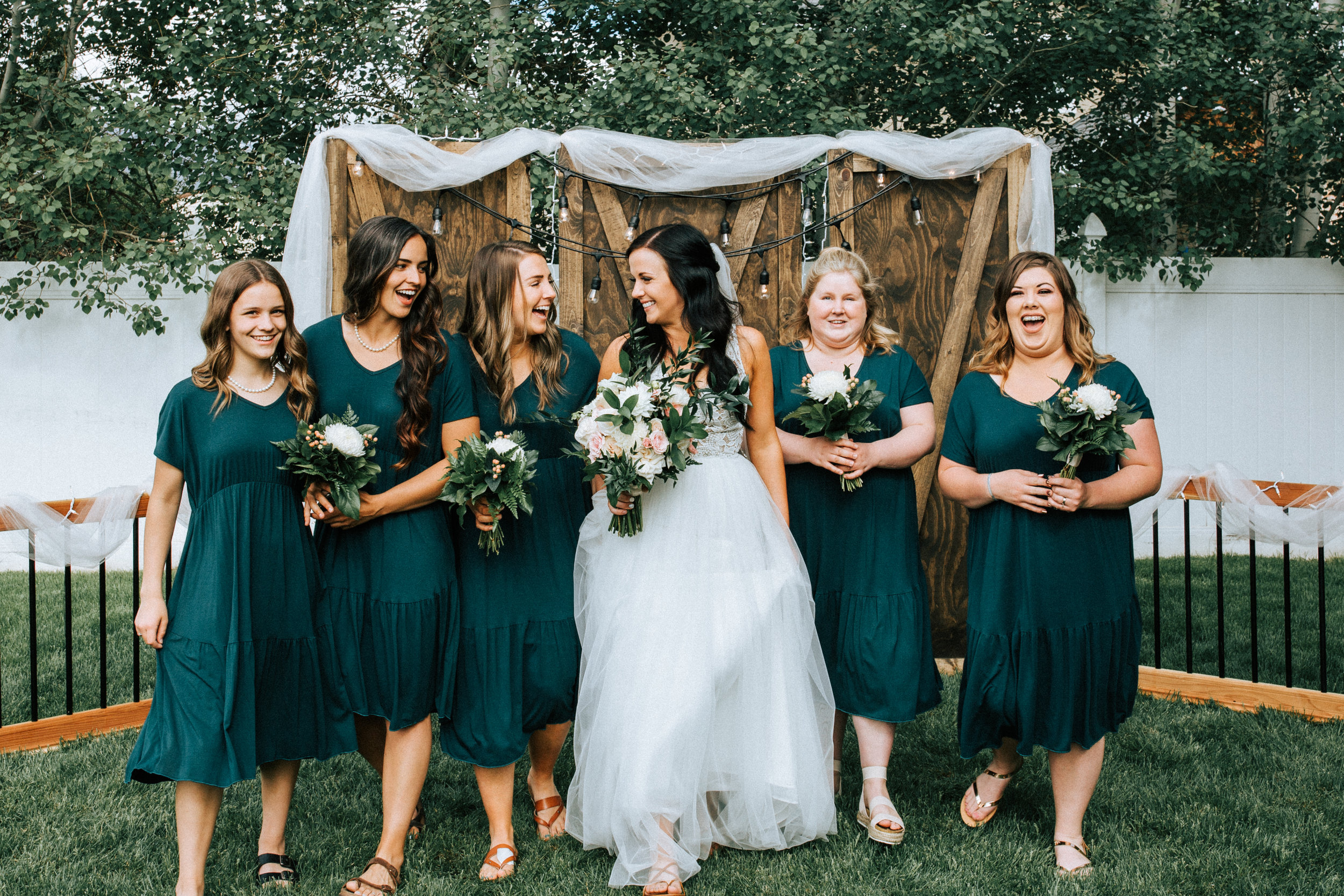 Bridesmaids teal dresses green white bouquets