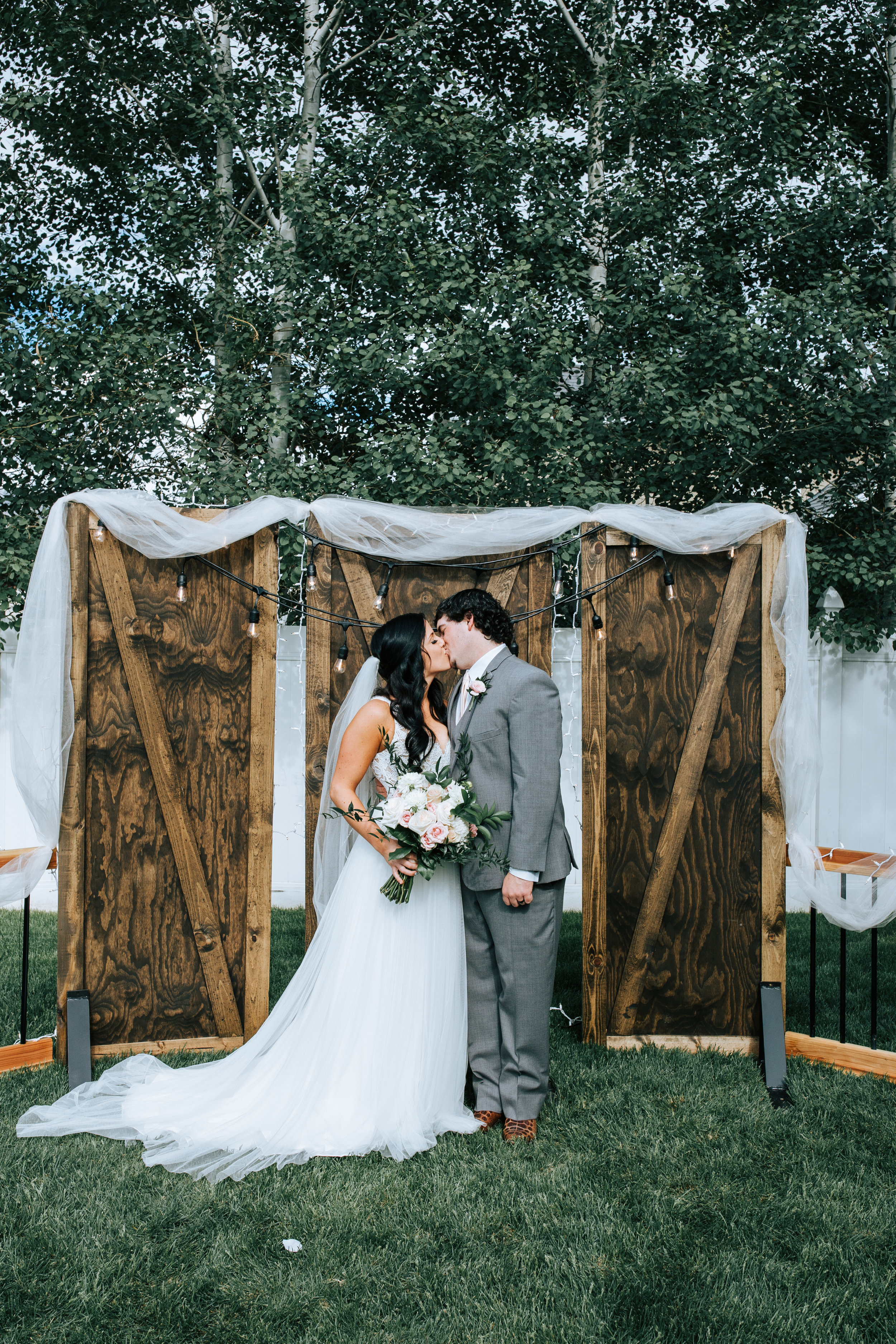 Utah Bride and groom backyard wedding hanging lights