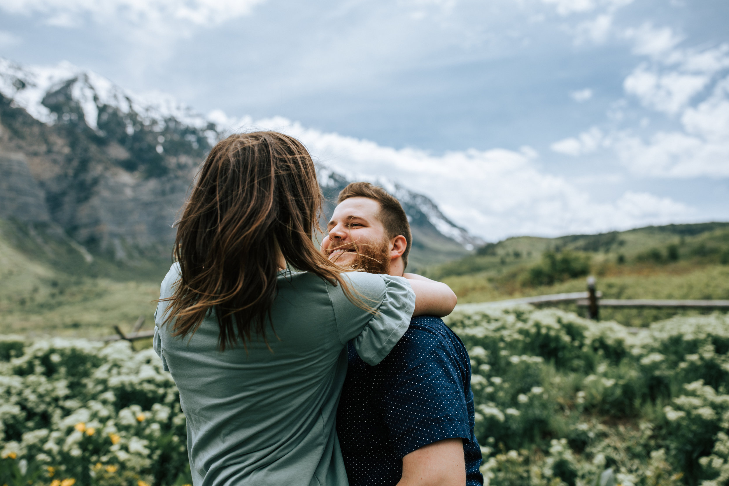 Windy mountain couples photos in Utah windflower field