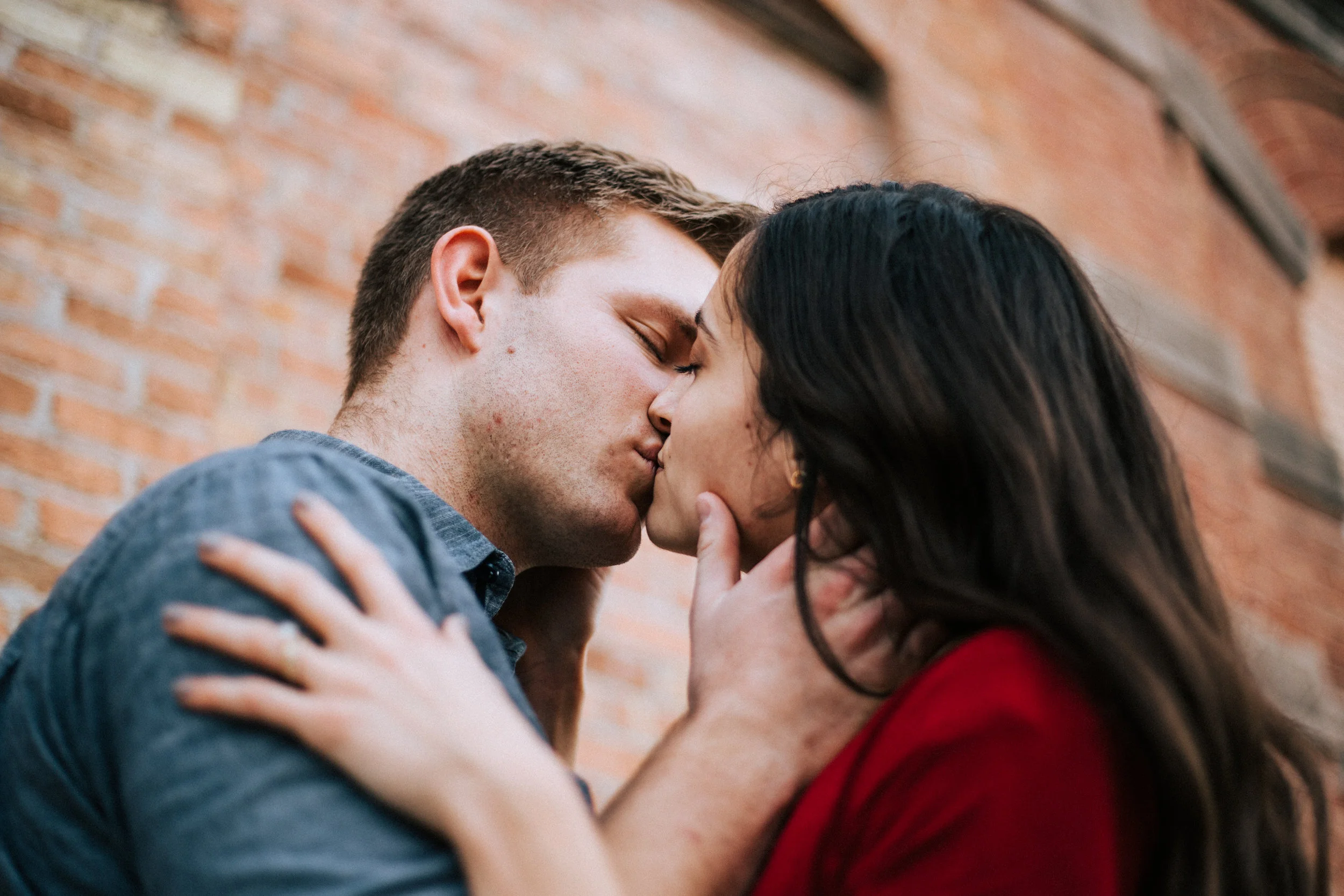 Downtown city couple portraits Utah romantic kiss