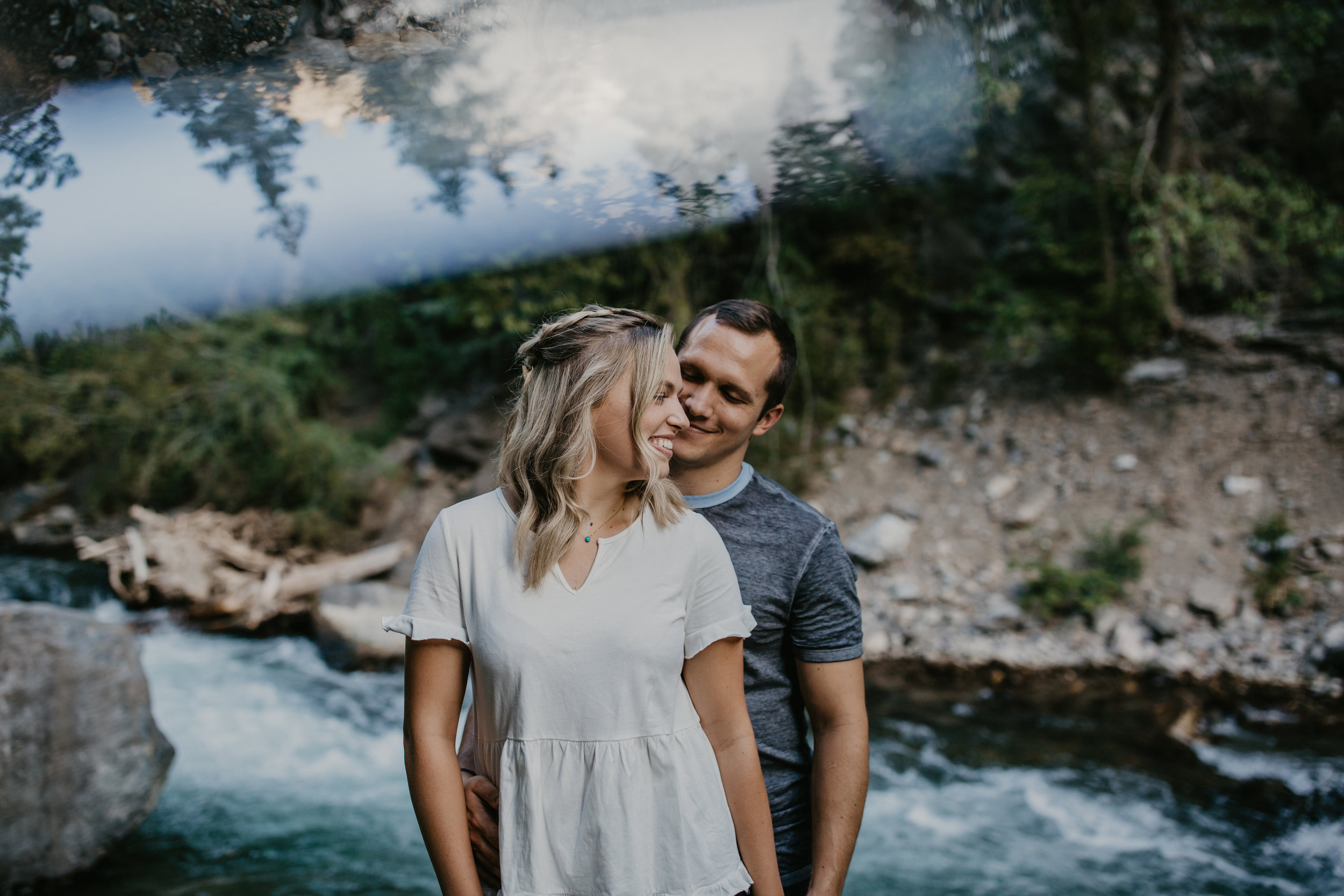 Utah mountain engagement couple by river with prism