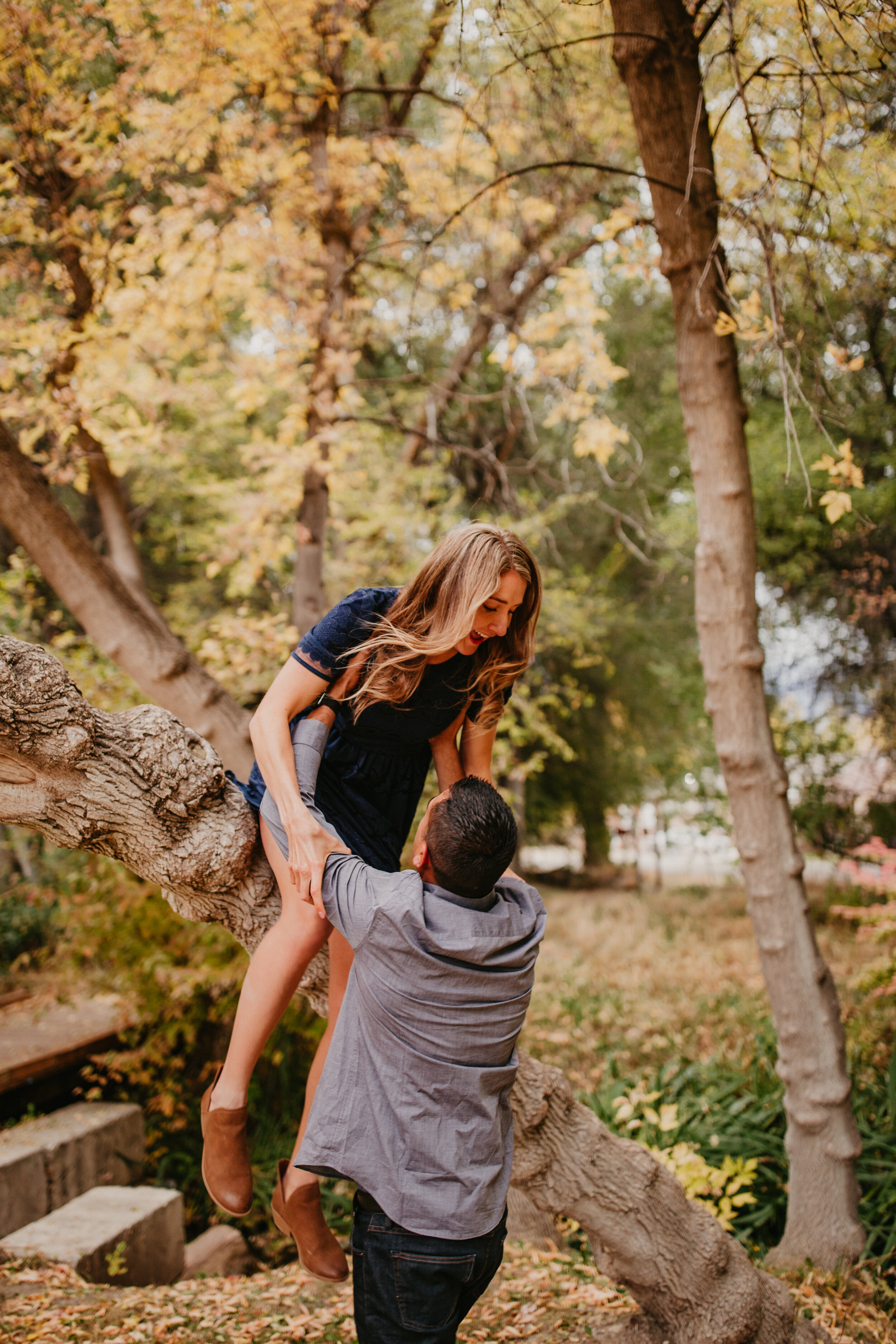Utah fall engagement photos climbing tree jumping out of tree couple