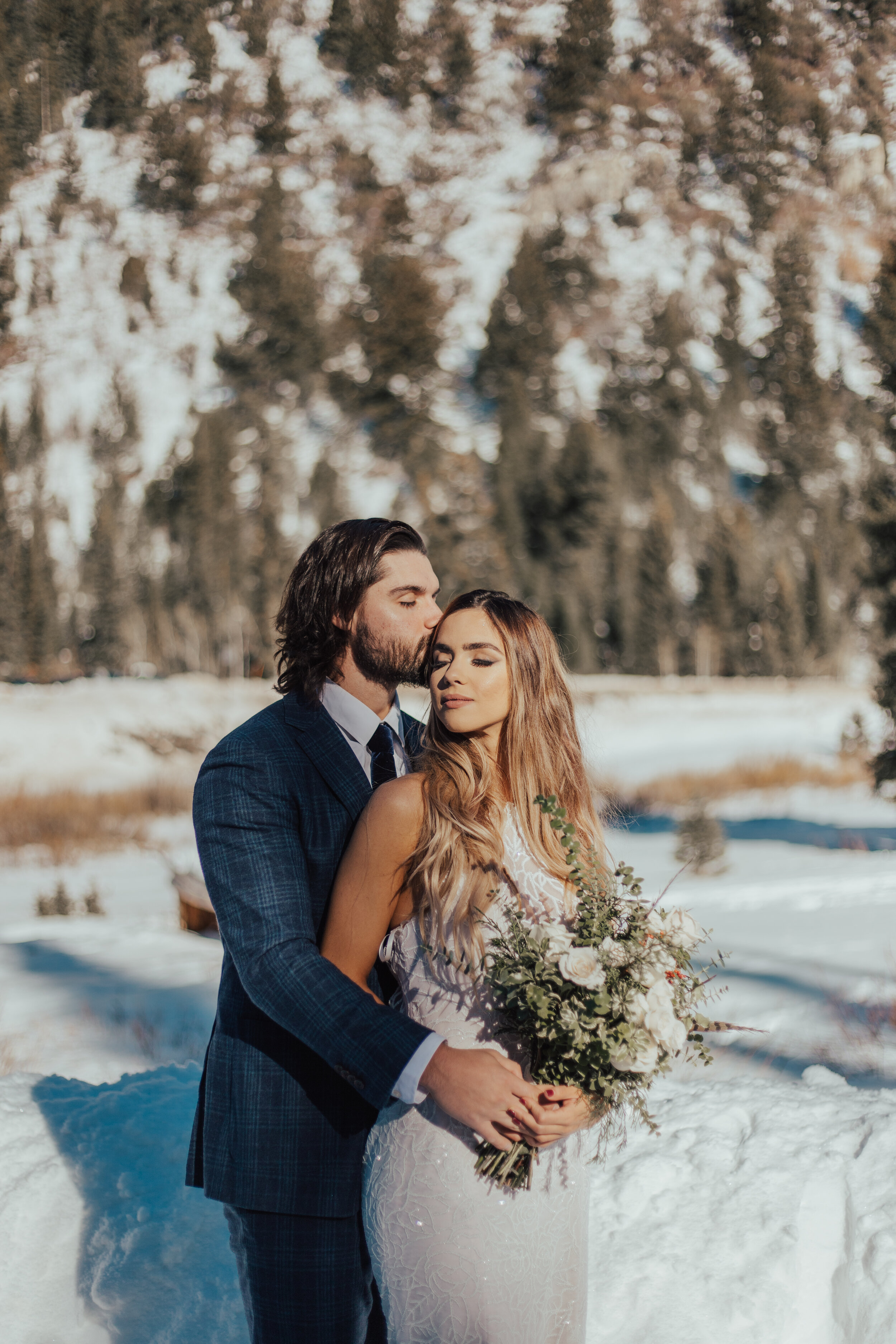 Winter mountain snowy bridals formal session bride groom sun flare pine trees wedding photos dress beard #bridals #weddingphotos #brideandgroom #utahphotographer #weddingphotographer #winterwedding
