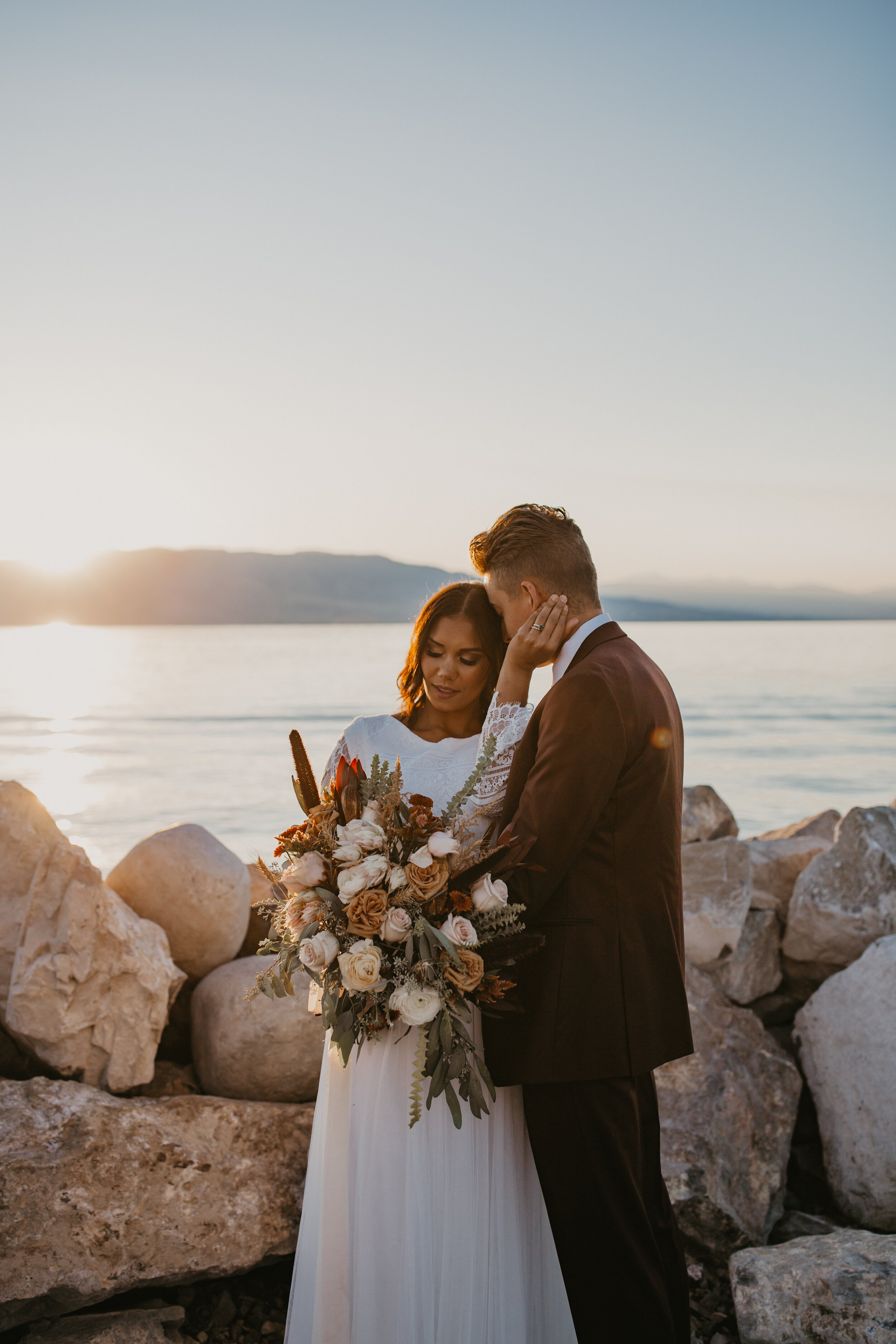 Sunset bridals bouquet wedding dress bride and groom lake ocean beach mountains Utah lake marina #utahphotographer #weddingphotographer #bride #bridals #brideandgroom #weddingphotos