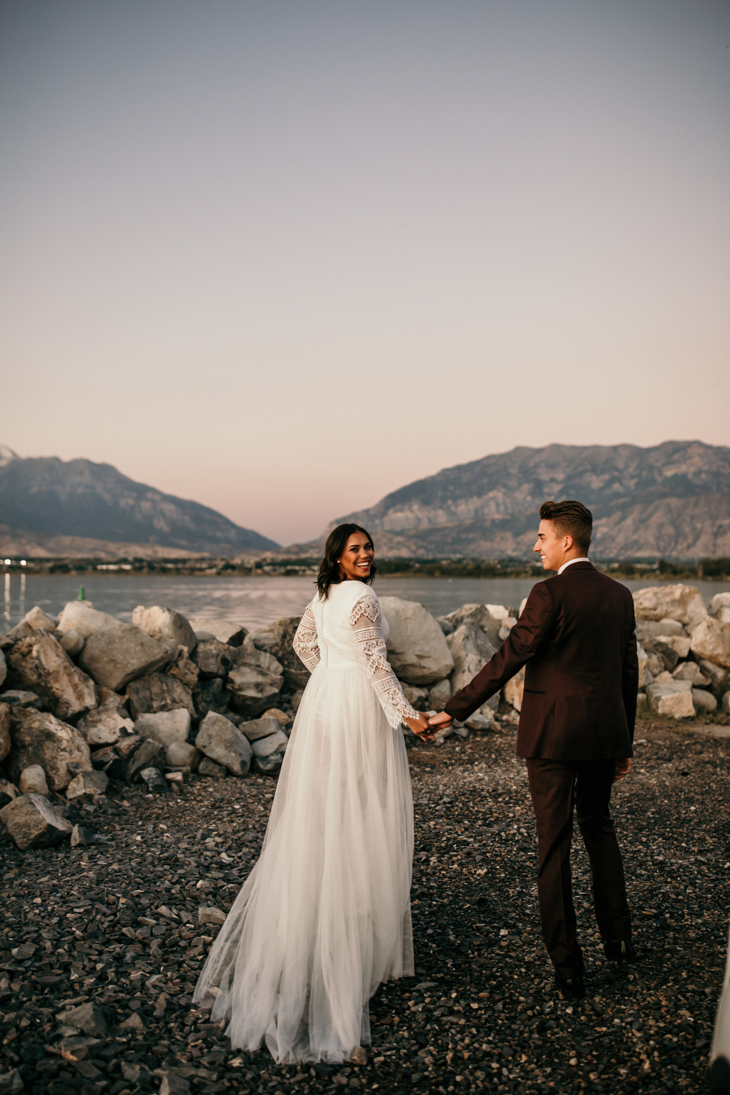 Sunset mountains bridals bouquet wedding dress bride and groom lake ocean beach Utah lake marina #utahphotographer #weddingphotographer #bride #bridals #brideandgroom #weddingphotos