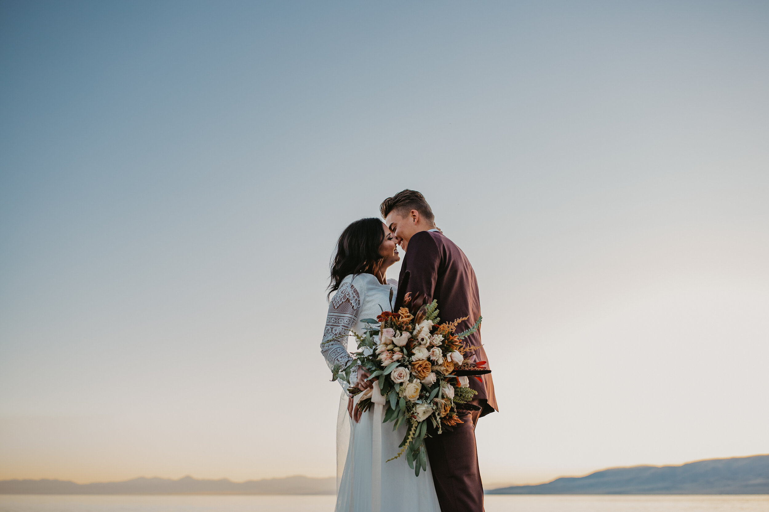 Sunset bridals bouquet wedding dress bride and groom lake ocean beach Utah lake marina #utahphotographer #weddingphotographer #bride #bridals #brideandgroom #weddingphotos