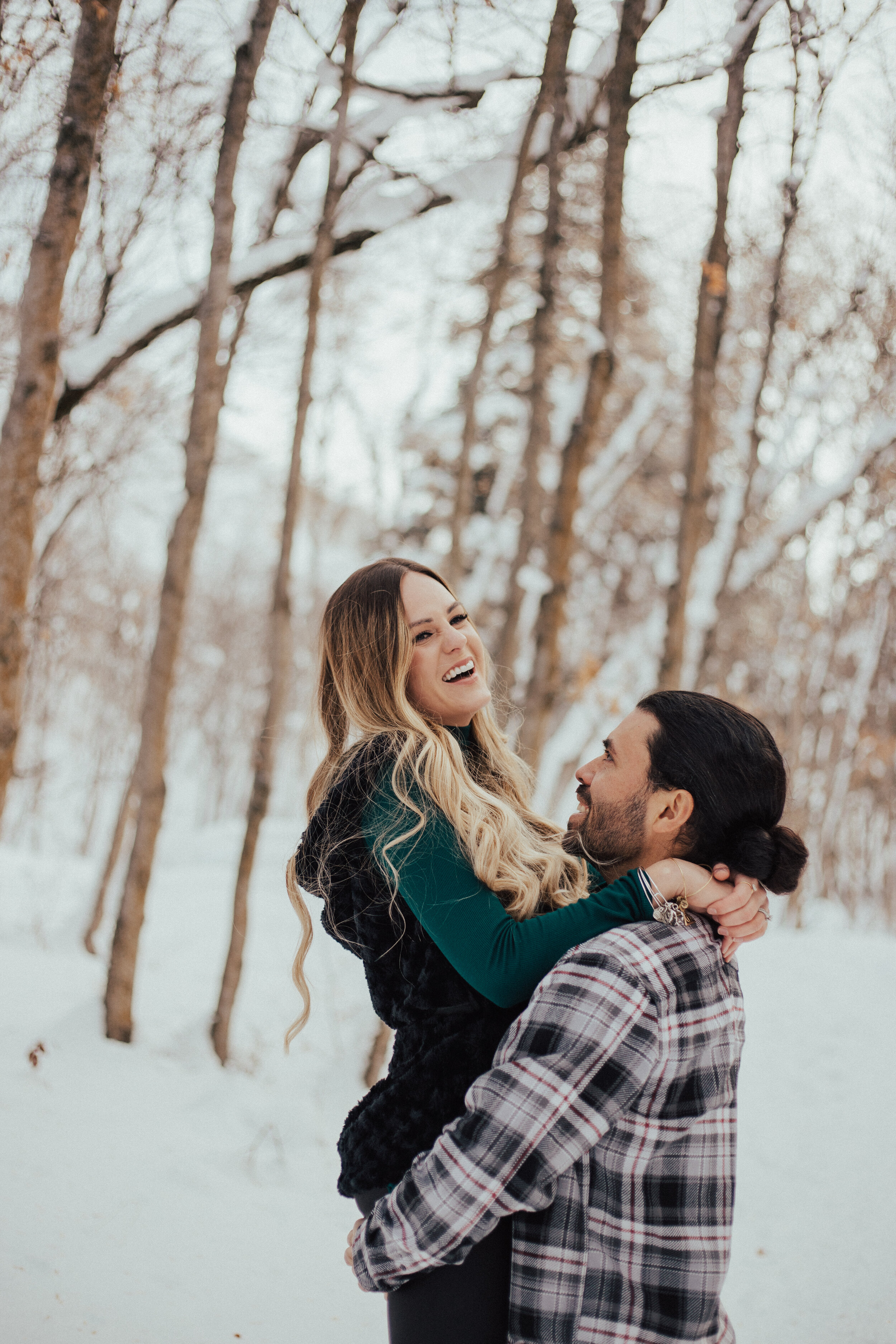 Snowy winter mountain couple laughing anniversary shoot engagement session romantic playful happy #utahphotographer #weddingphotographer #engagements #coupleshoot #engagementsession