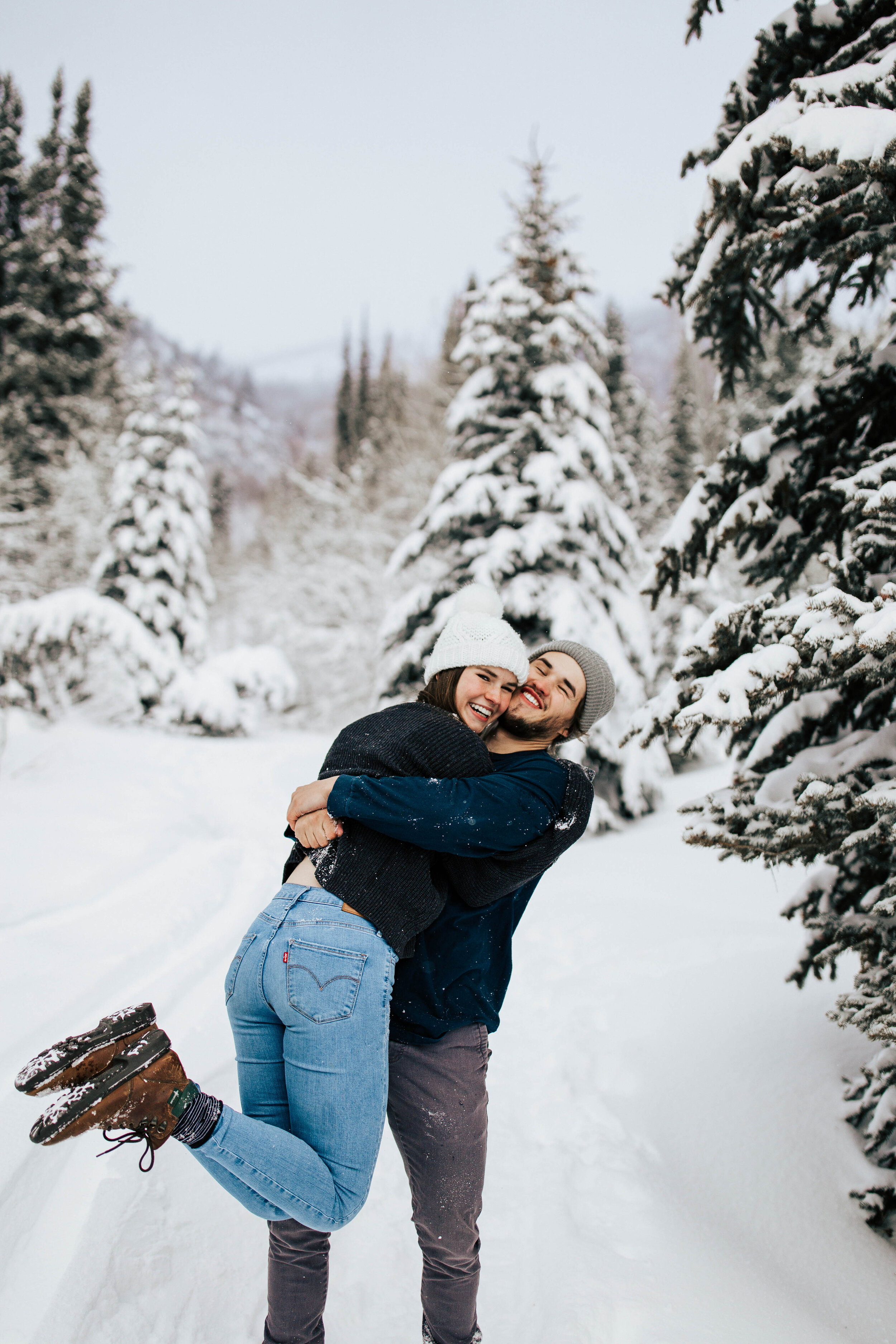 Cozy winter couple shoot beanies coats blankets snuggling snowy mountains pine trees adventurous #utahphotographer #coupleshoot #engagementsession #engagementshoot #weddingphotographer