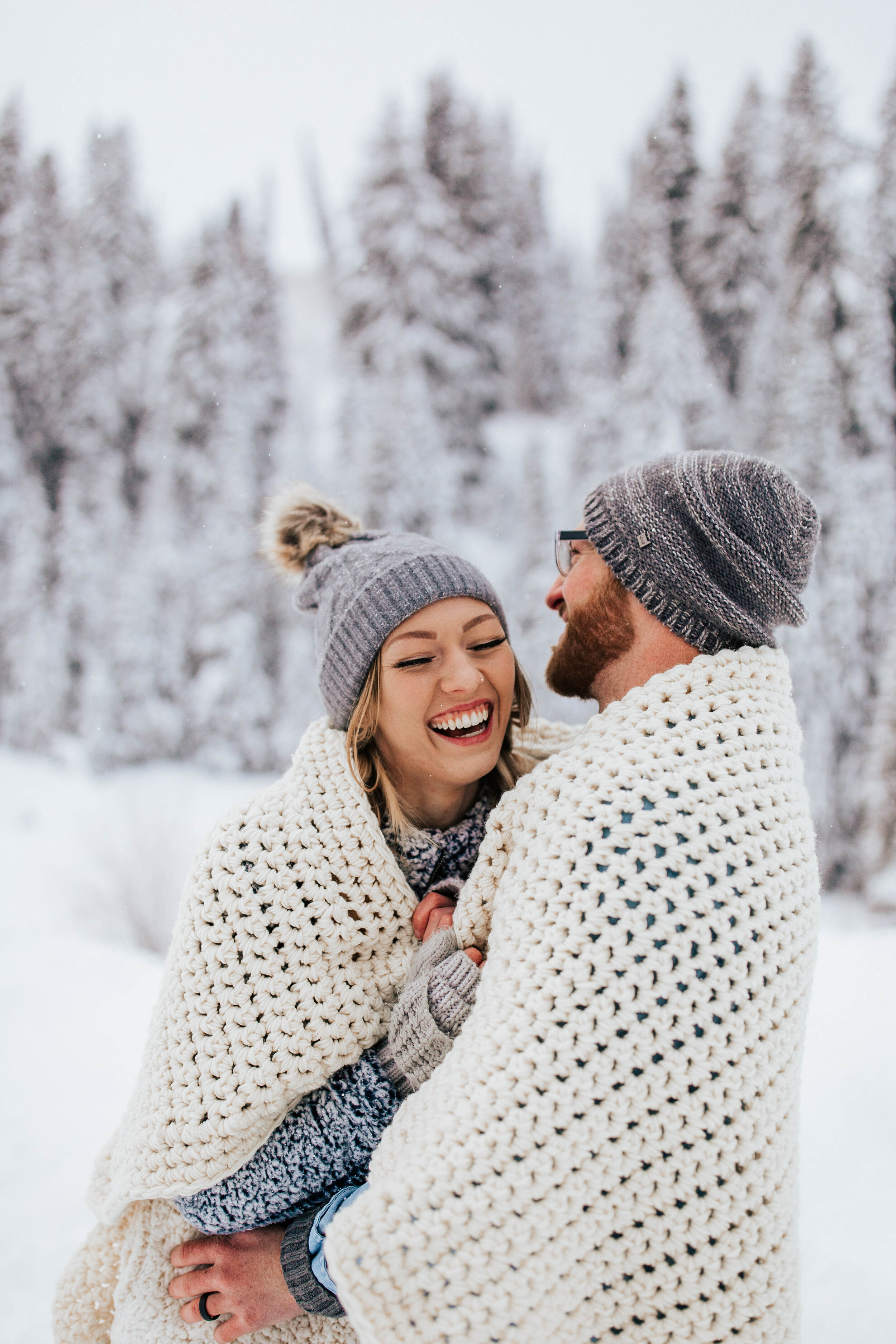 Cozy winter couple shoot beanies coats blankets snuggling snowy mountains pine trees adventurous #utahphotographer #coupleshoot #engagementsession #engagementshoot #weddingphotographer blanket