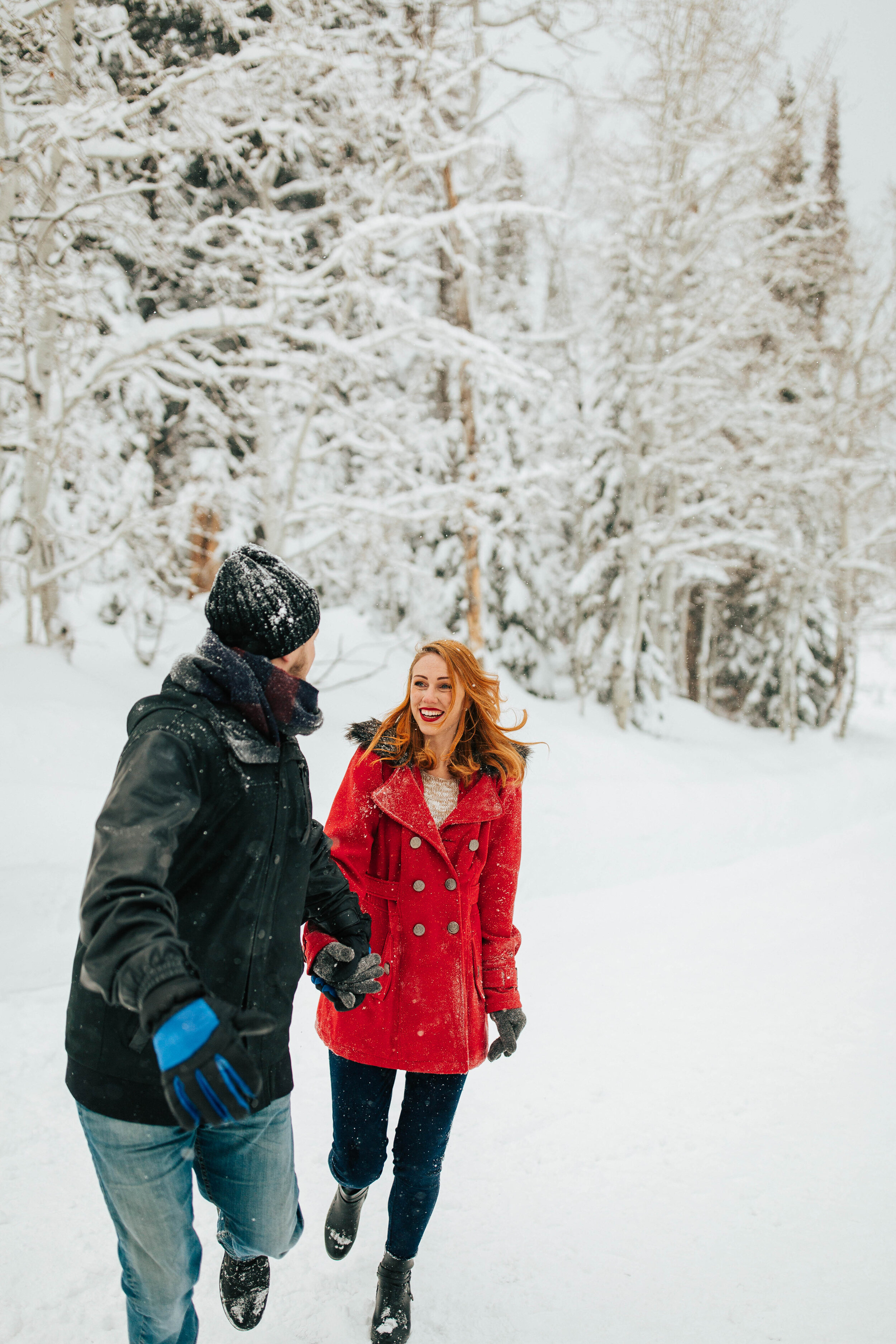 Winter couples session engagements snow mountains cozy wrapped in blanket #coupleshoot #utahphotographer #weddingphotographer #engagementsession #engagementshoot running playing in snow